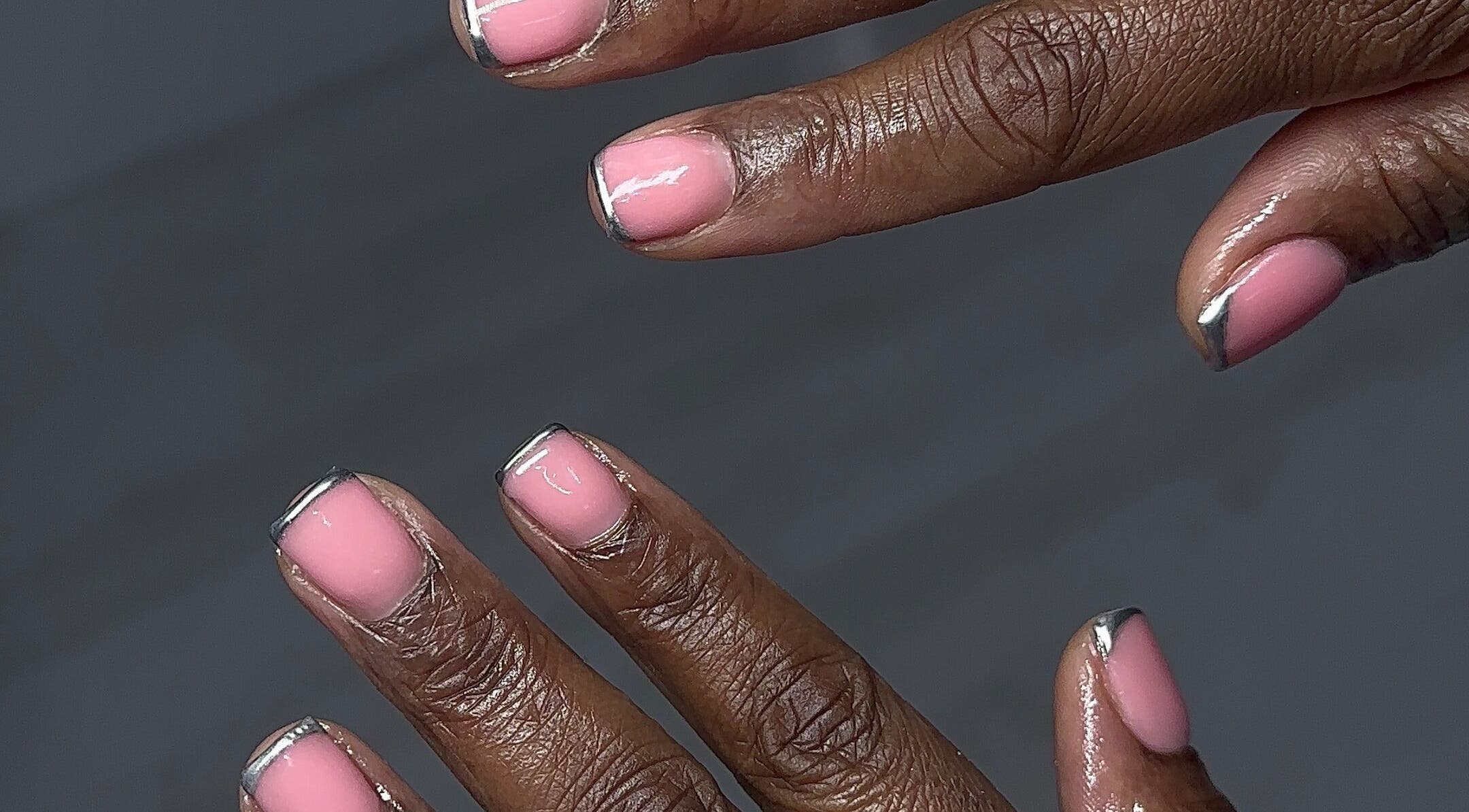 Stylish pink manicure with silver tips at Nailedbylaurinda, Birmingham, England, GB.