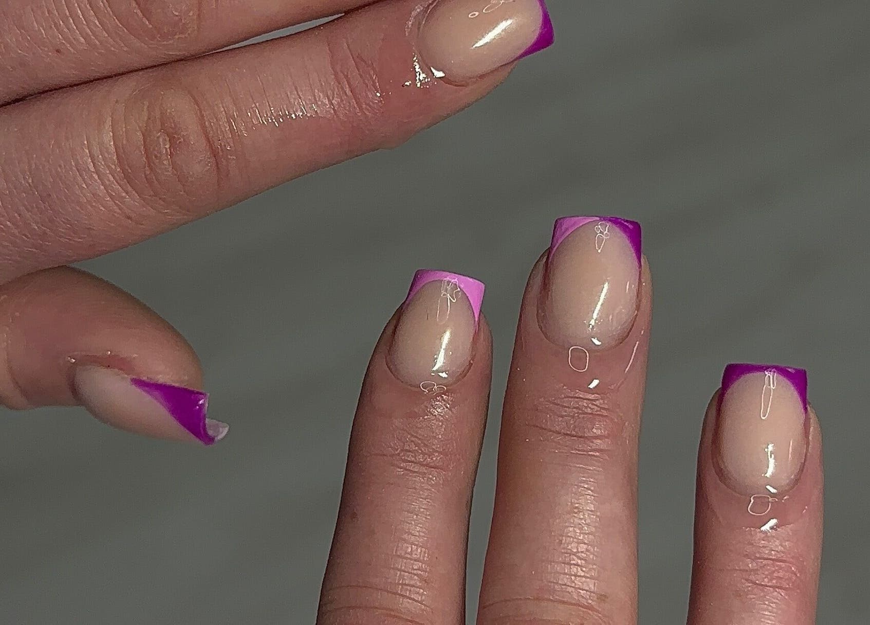 Close-up of purple-tipped nails at Nailedbylaurinda, Birmingham, England, GB showcasing stylish manicure.