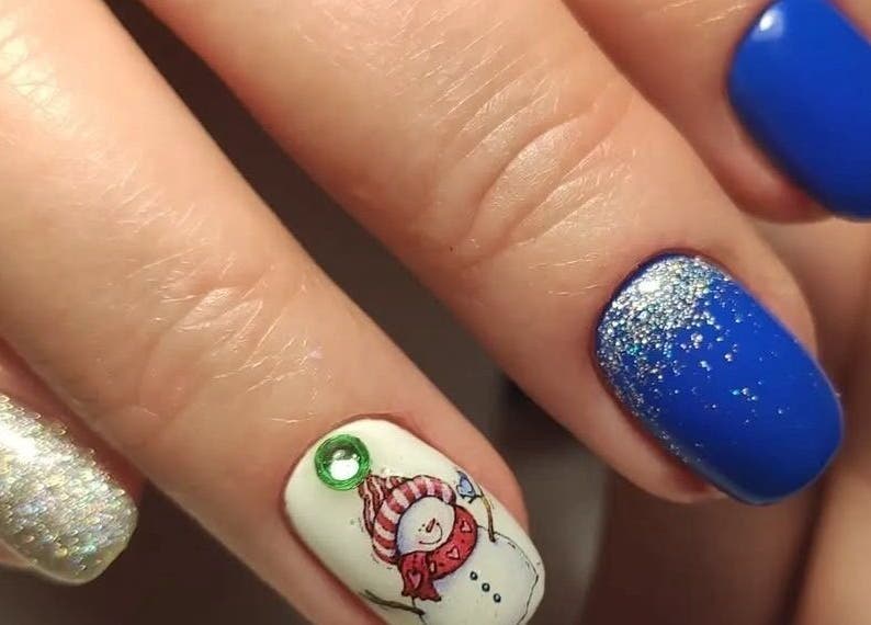 Festive nail art at Stirling Nail Art, Stirling, Scotland, GB featuring blue, silver, and snowman designs.