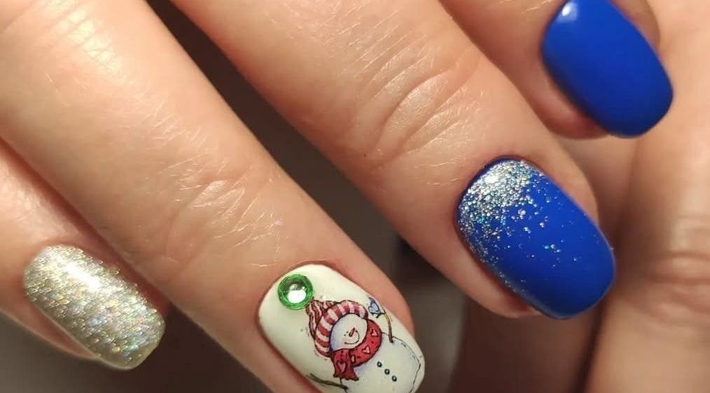 Festive nail art at Stirling Nail Art, Stirling, Scotland, GB featuring blue, silver, and snowman designs.