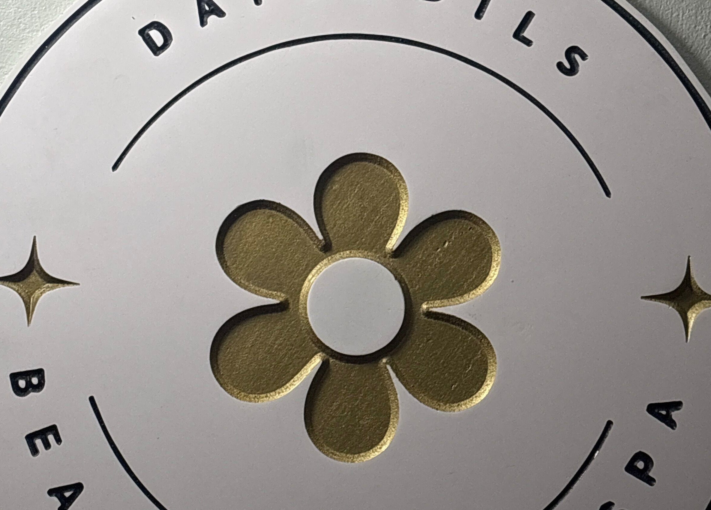 Logo of daffodils beauty salon & spa in Basseterre, Saint George Basseterre Parish, KN with gold flower design.
