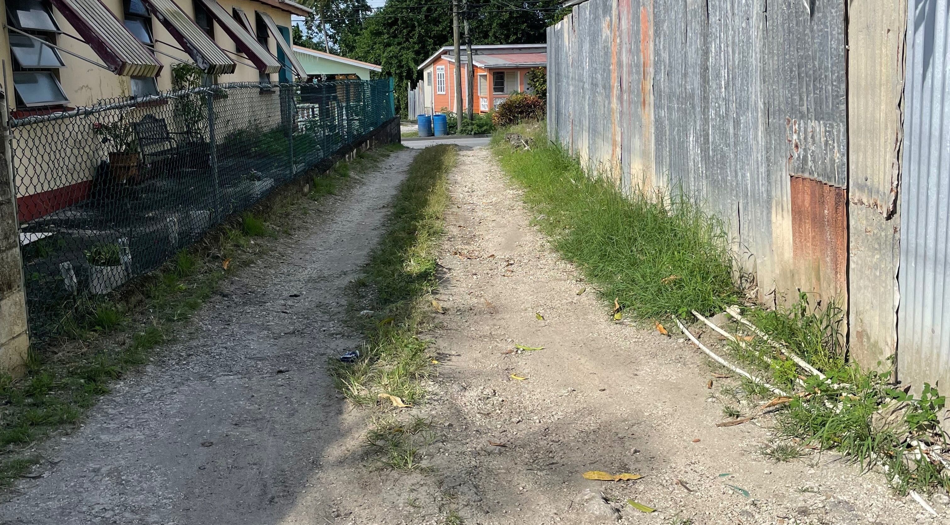 Rustic pathway leading to The Luxe Nail Art Studio in Bridgetown, Saint Michael, BB, showcasing local charm.