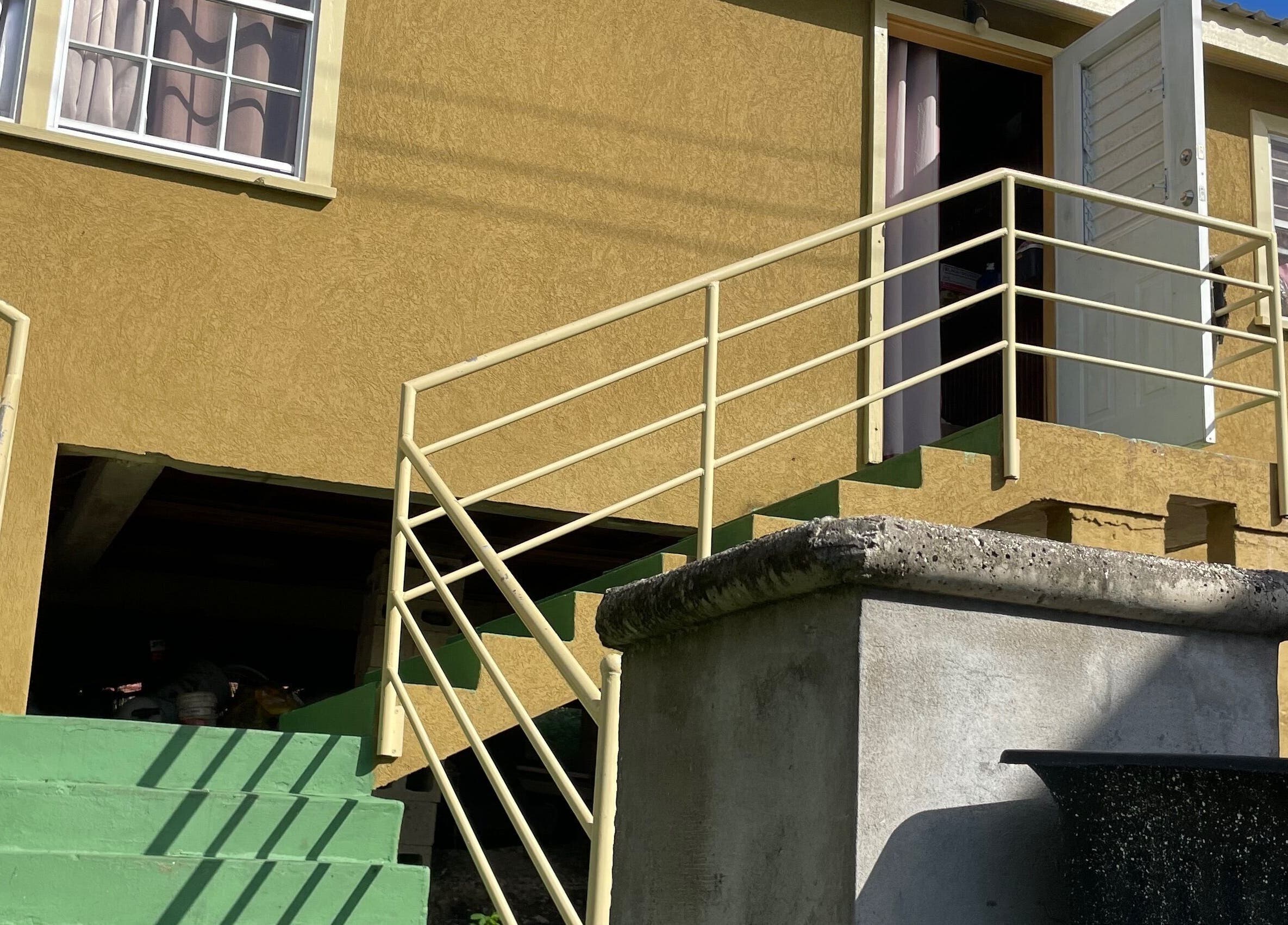 Entrance to The Luxe Nail Art Studio in Bridgetown, Saint Michael, BB, highlighted by stairs and bright sunlight.