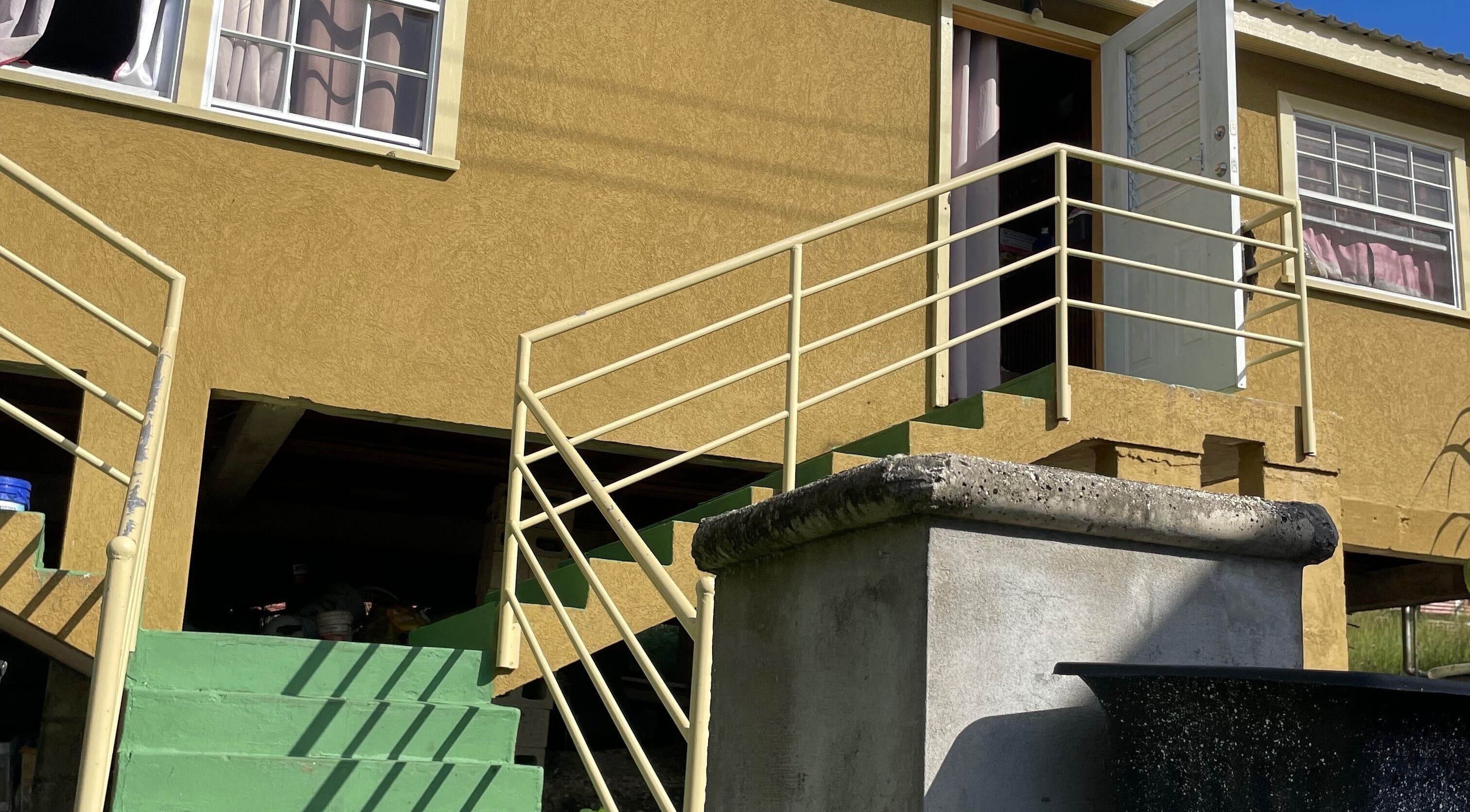 Entrance to The Luxe Nail Art Studio in Bridgetown, Saint Michael, BB, highlighted by stairs and bright sunlight.