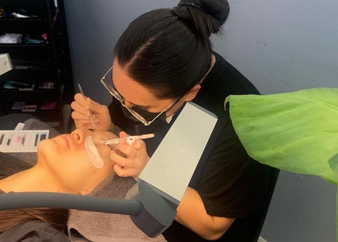 Eyelash technician at Lash and Brow Cribb in Tamahere, Waikato, NZ applying lashes with precision tools.