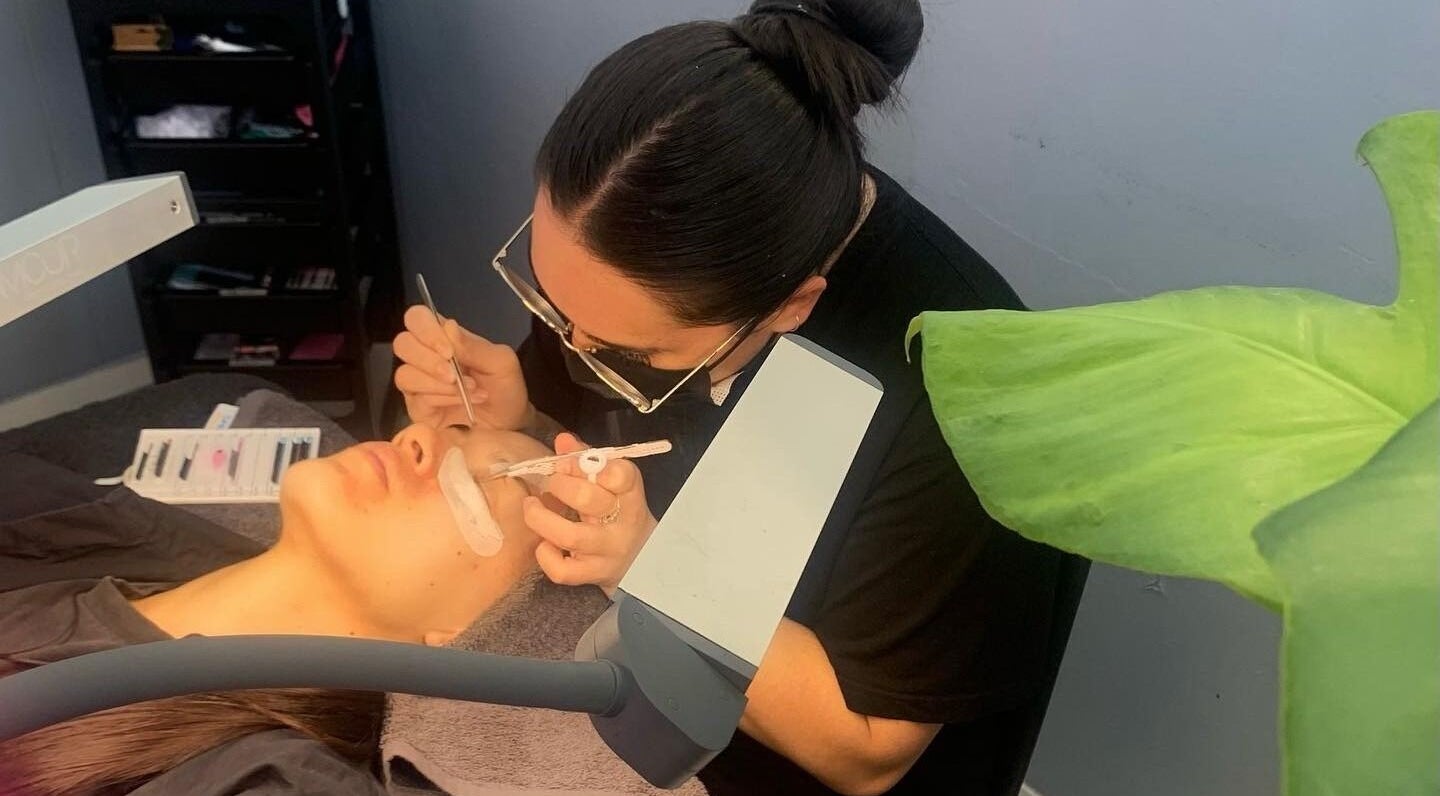 Eyelash technician at Lash and Brow Cribb in Tamahere, Waikato, NZ applying lashes with precision tools.