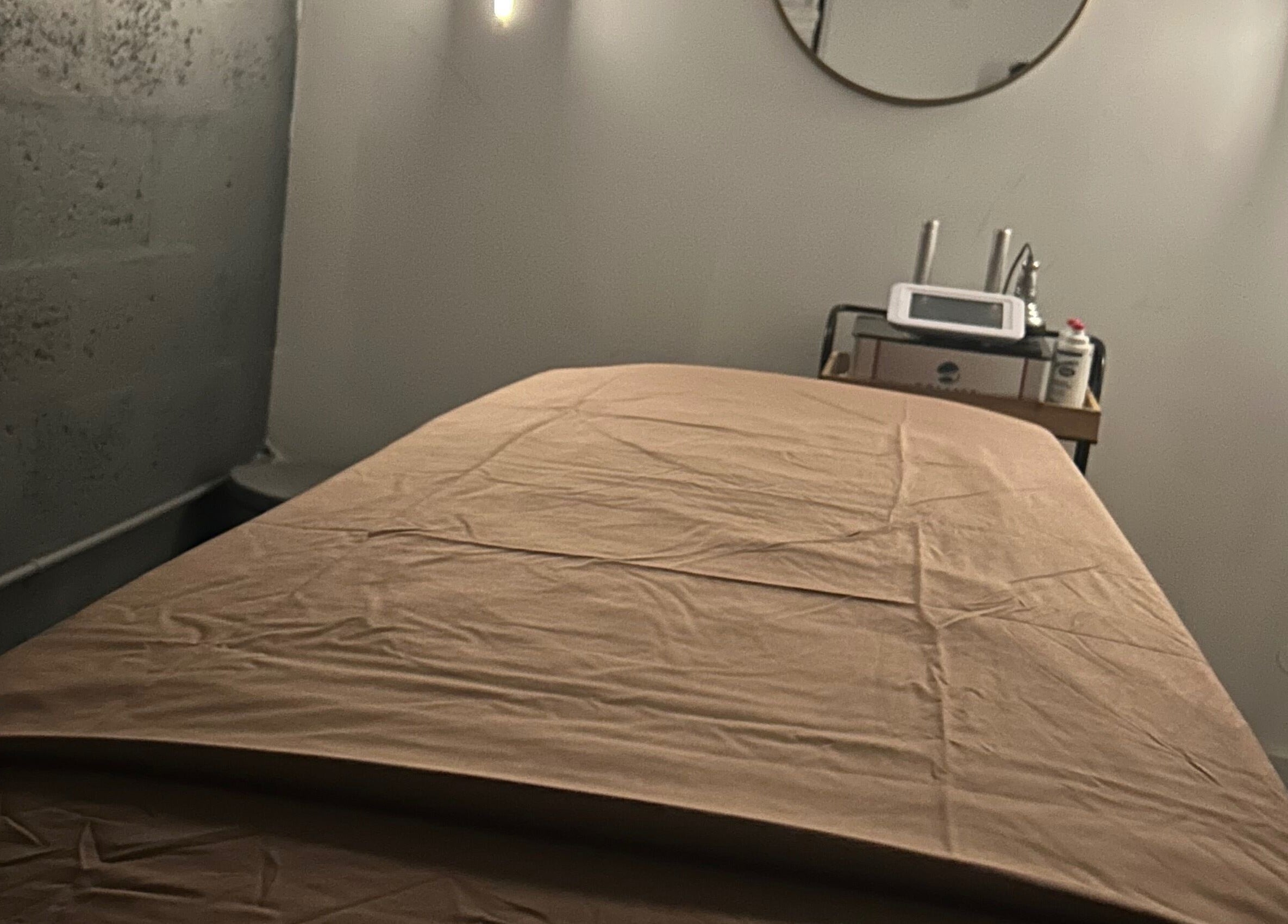 Treatment room at Voilá Esti Lab, Fort Lauderdale, Florida, US, equipped with a comfortable massage table.