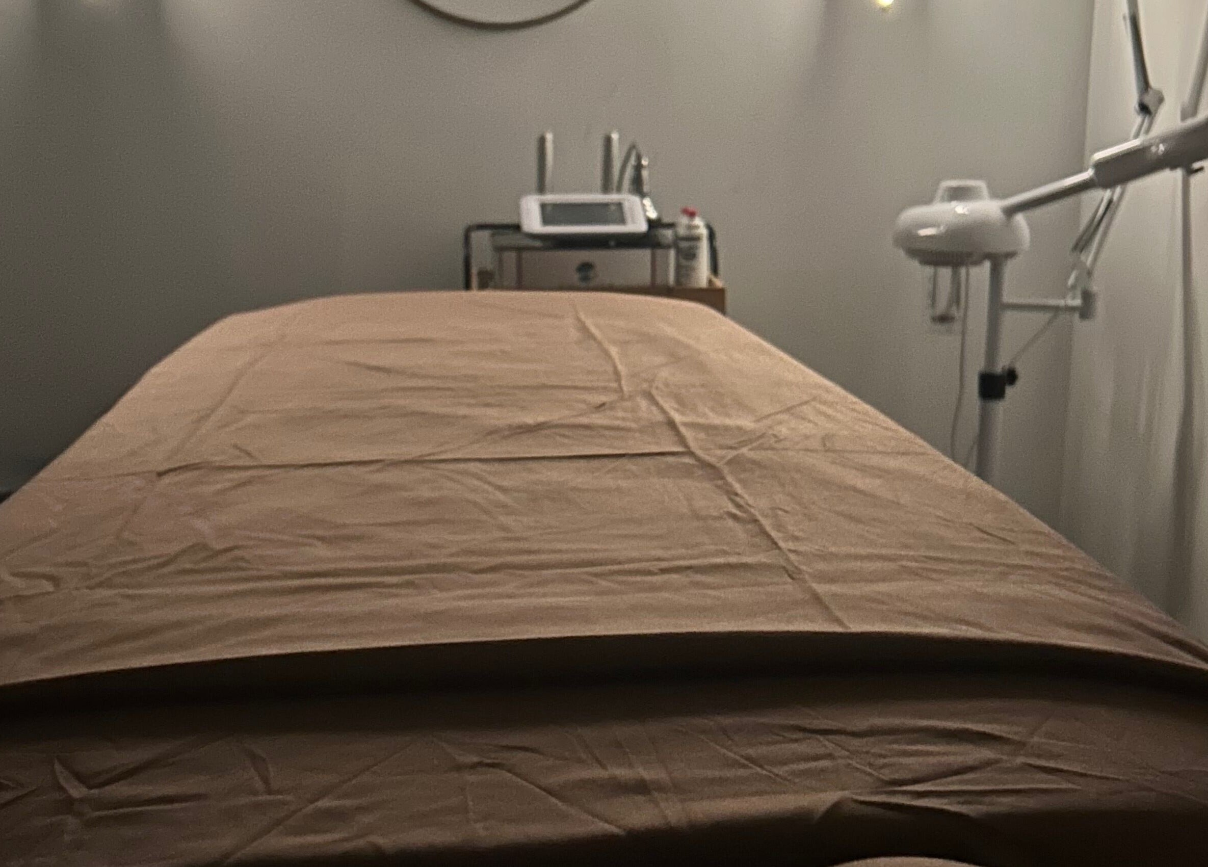 Luxurious treatment room at Voilá Esti Lab in Fort Lauderdale, Florida, US, showcasing a massage table and equipment.
