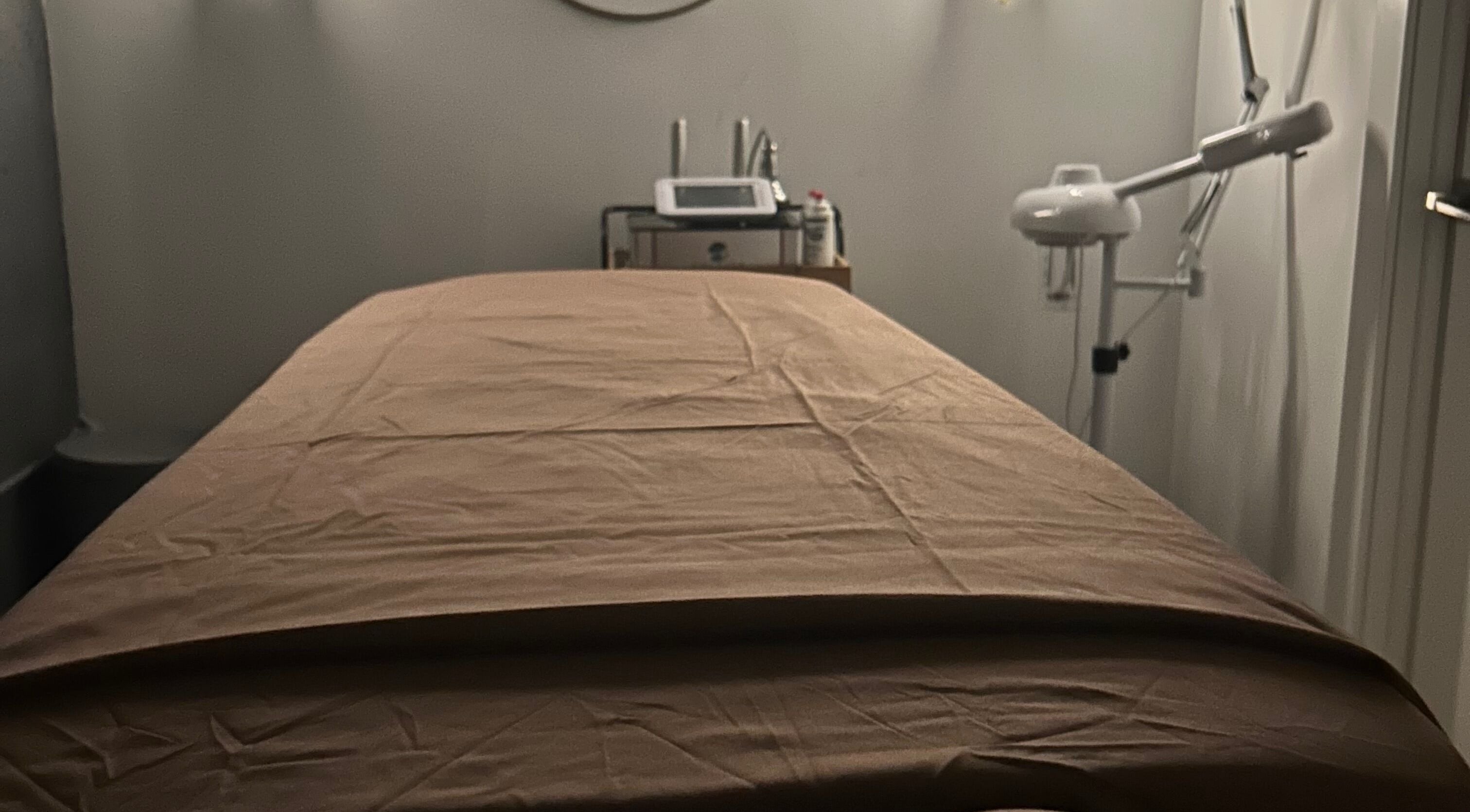 Luxurious treatment room at Voilá Esti Lab in Fort Lauderdale, Florida, US, showcasing a massage table and equipment.