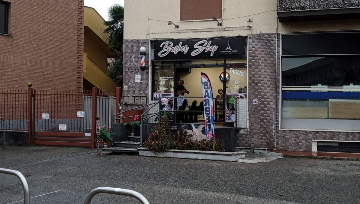 Exterior of a trendy barber shop at Paris by Italy, Paderno Dugnano, Lombardia, IT.