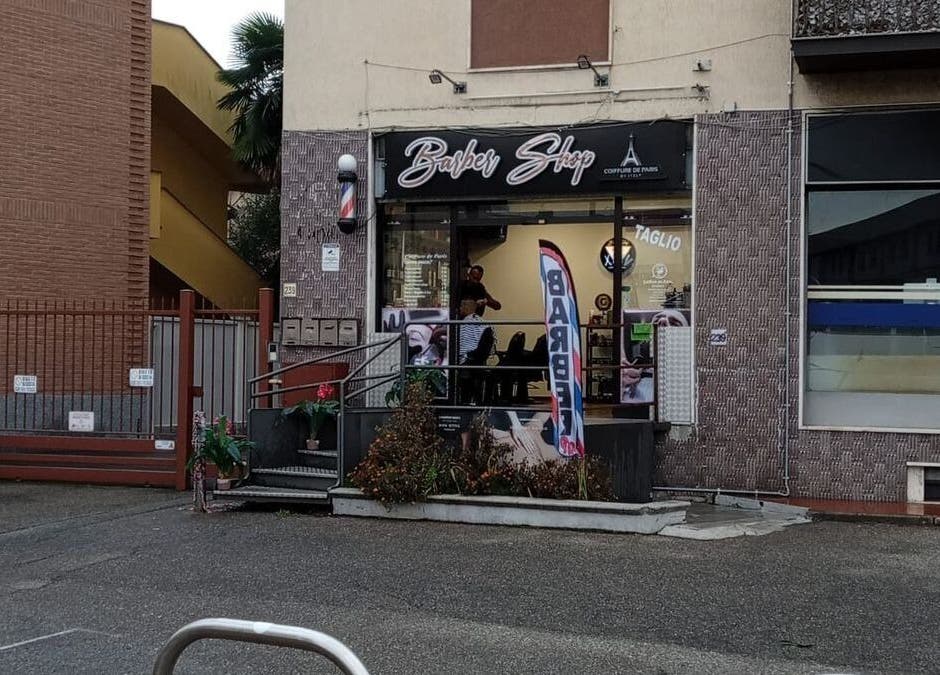 Exterior of a trendy barber shop at Paris by Italy, Paderno Dugnano, Lombardia, IT.