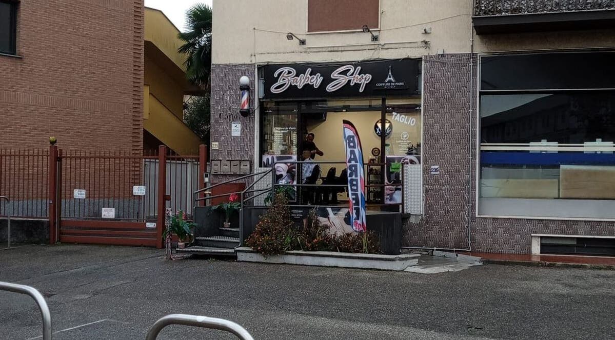 Exterior of a trendy barber shop at Paris by Italy, Paderno Dugnano, Lombardia, IT.
