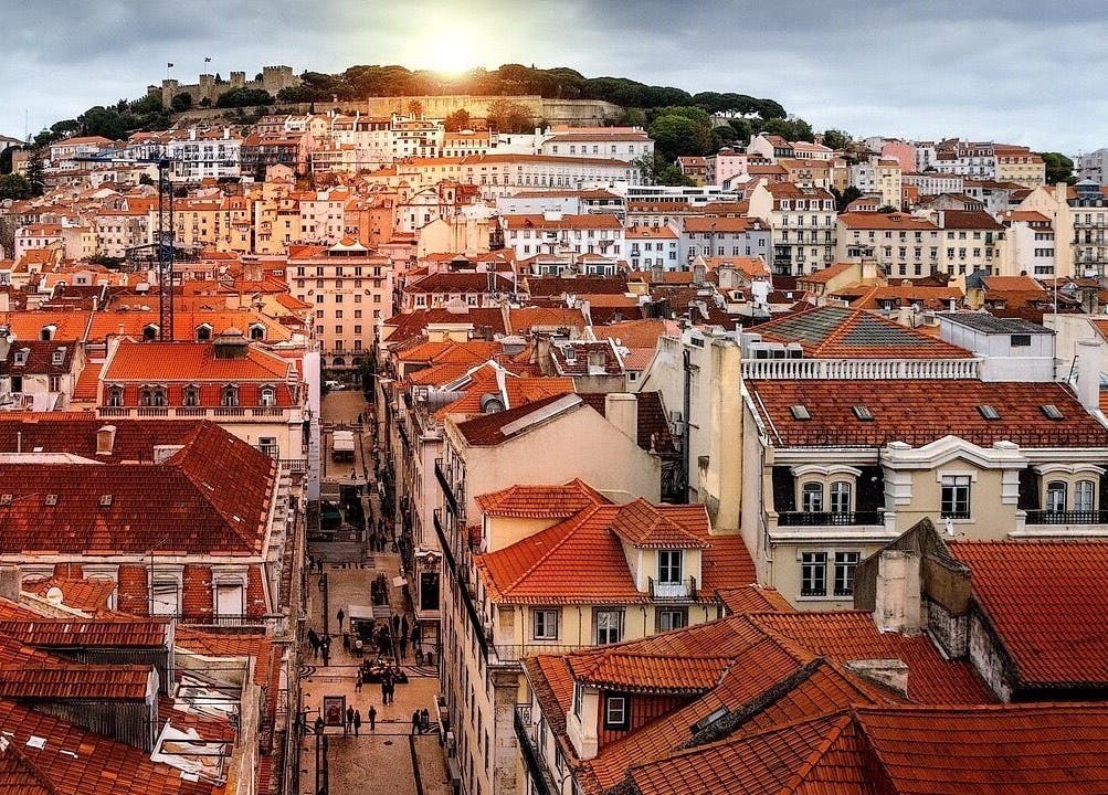 Sunset over Lisboa rooftops near Lomi Lomi Massage & Meditation, Lisboa, Lisboa, PT, creating a serene atmosphere.