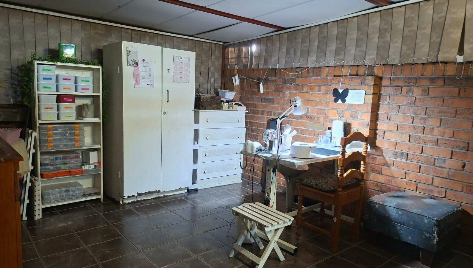 Cozy manicure station at Nails by Roelene, Krugersdorp, Gauteng, ZA with organized shelves.