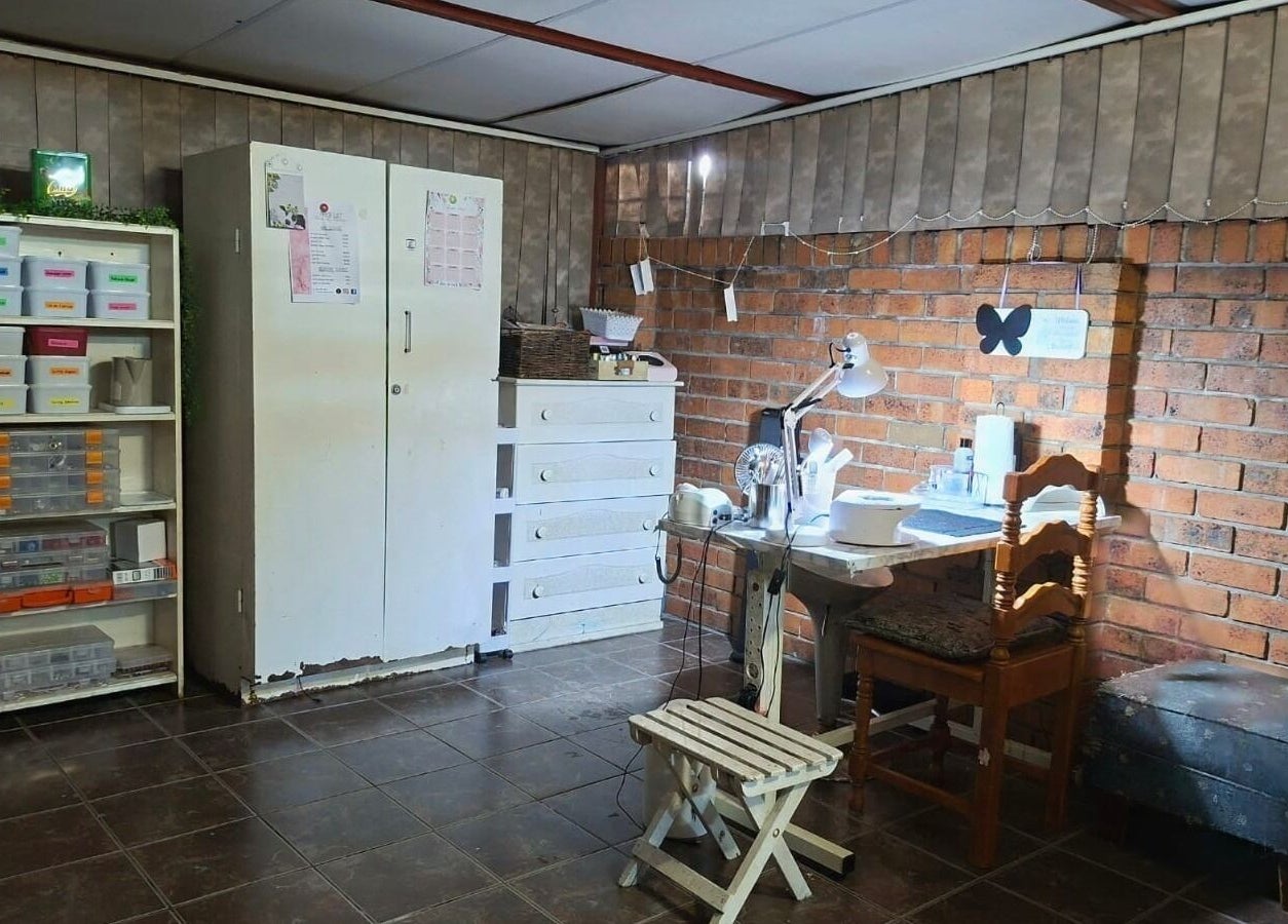Cozy manicure station at Nails by Roelene, Krugersdorp, Gauteng, ZA with organized shelves.