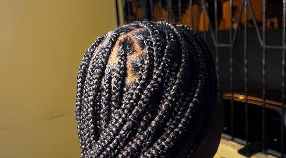 Intricate braided hairstyle at Lux_uriousempire, Port of Spain, offering top-notch beauty services.