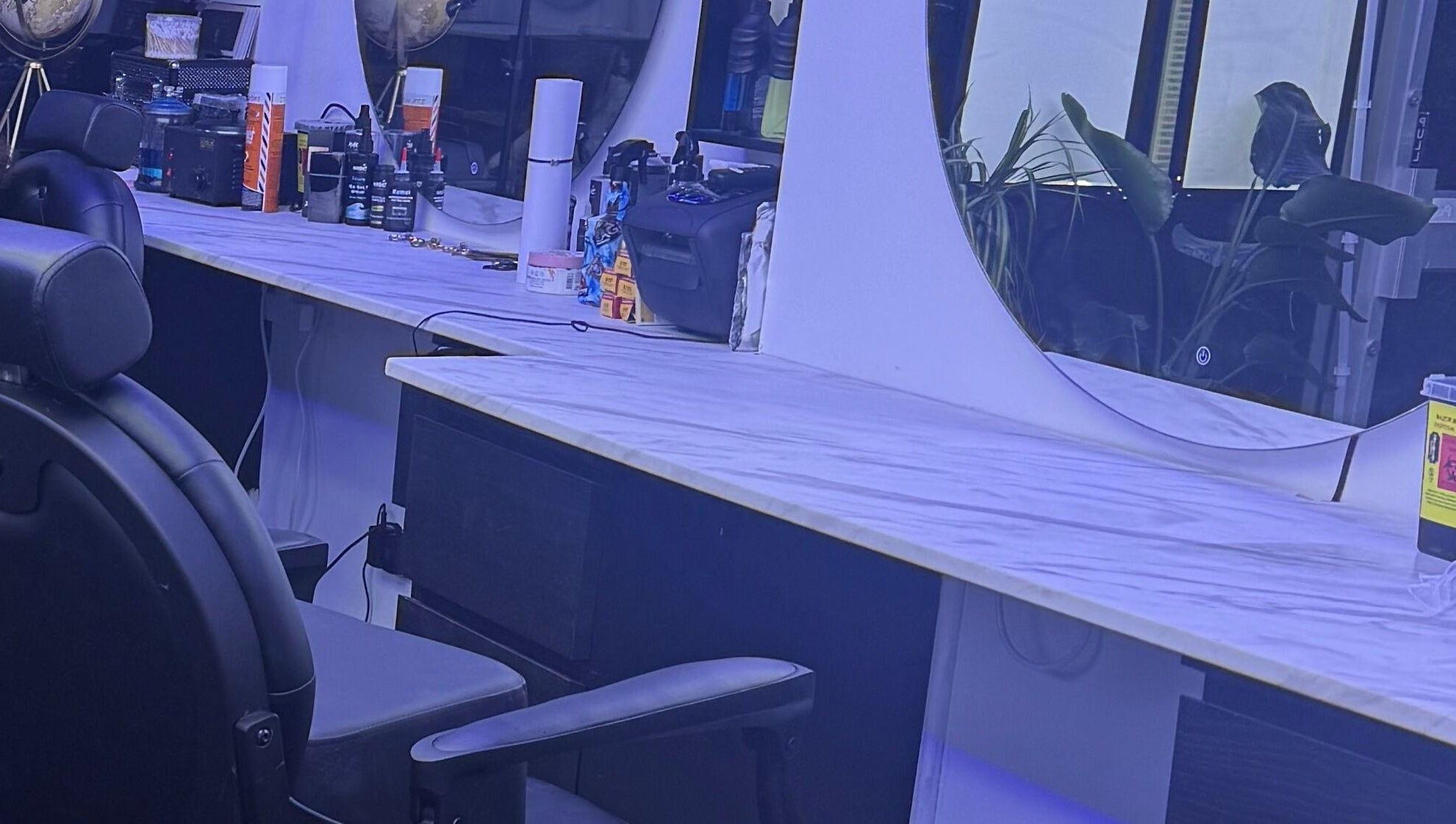 HE & SHE unisex salon, Bournemouth, England, GB showcases a stylish vanity with elegant mirrors and beauty products.