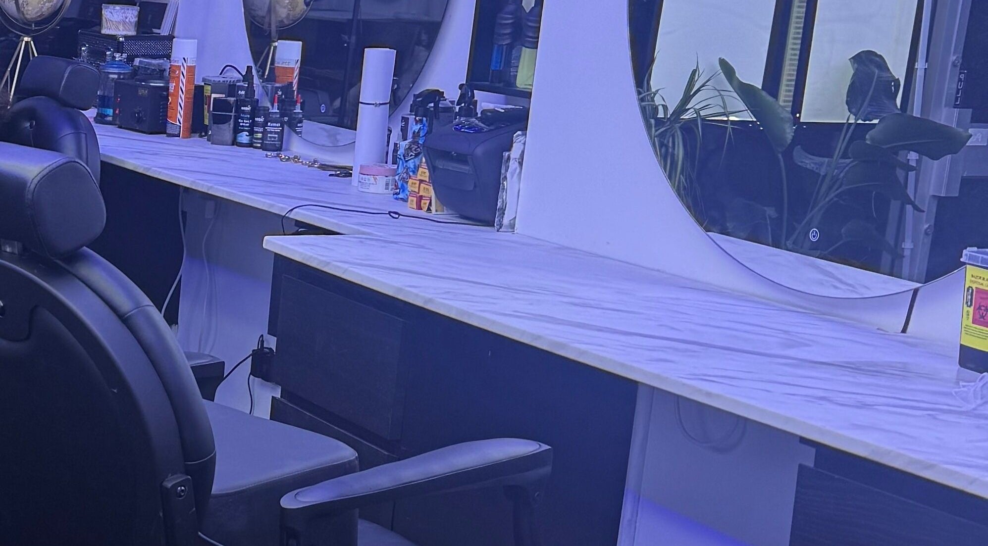 HE & SHE unisex salon, Bournemouth, England, GB showcases a stylish vanity with elegant mirrors and beauty products.