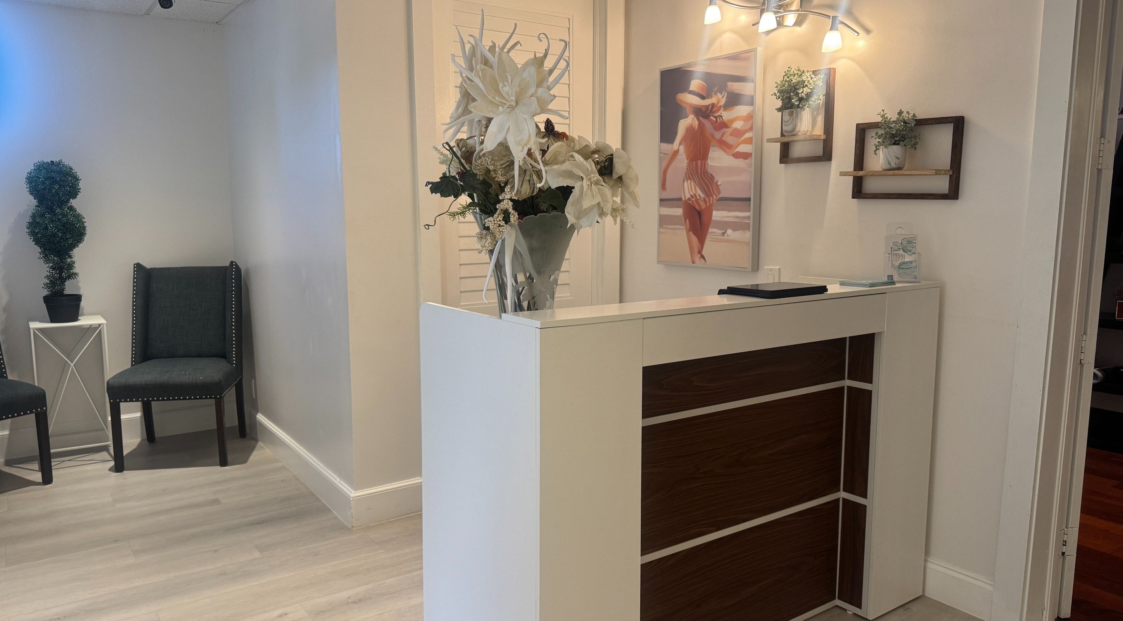 Reception area at Cryo Sculpting Lab - Boca, Boca Raton, Florida, US with flowers and seating.