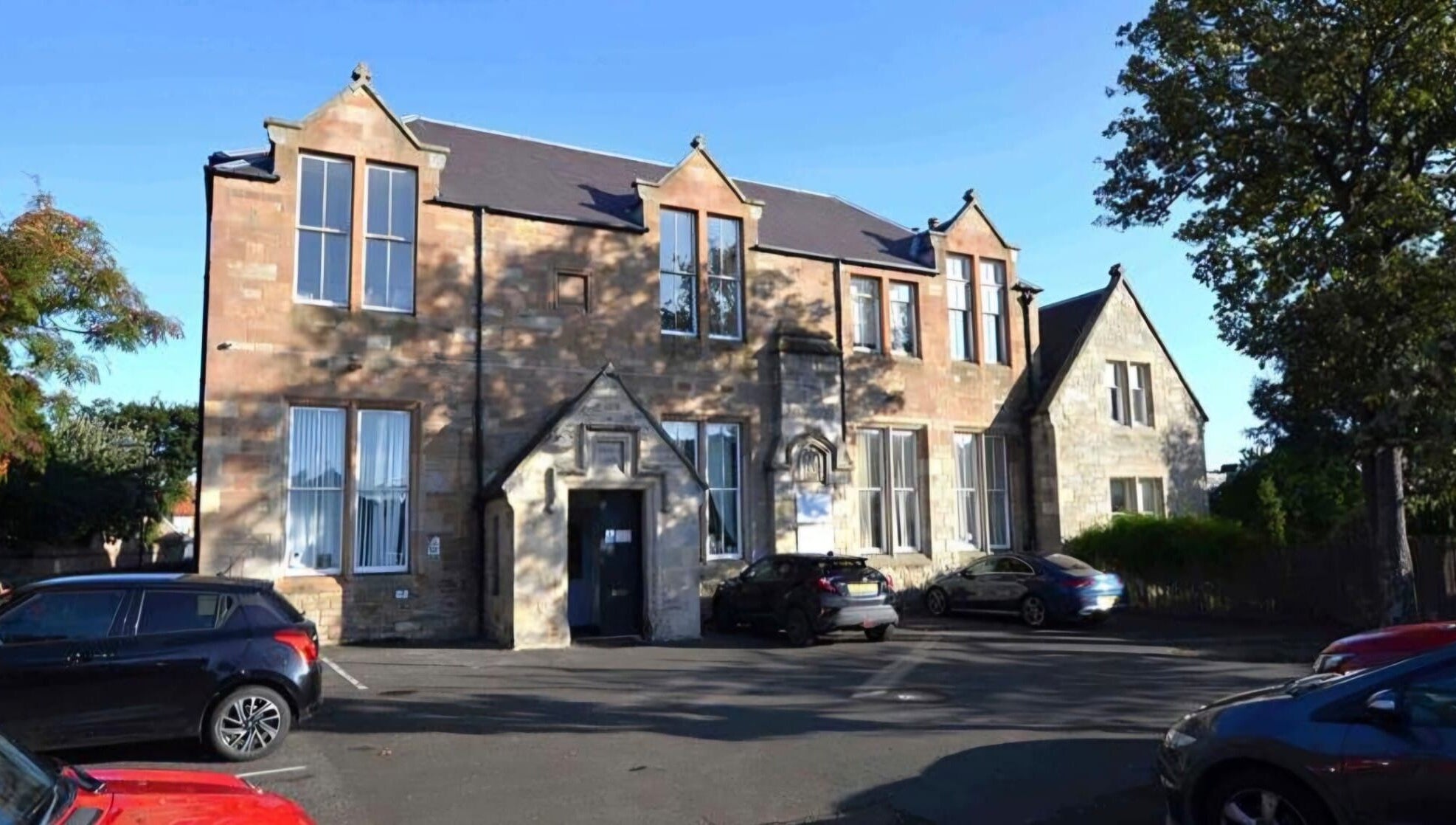Charming KD Beauty venue in Cockenzie, Scotland, GB, showcasing rustic stone architecture under clear blue sky.