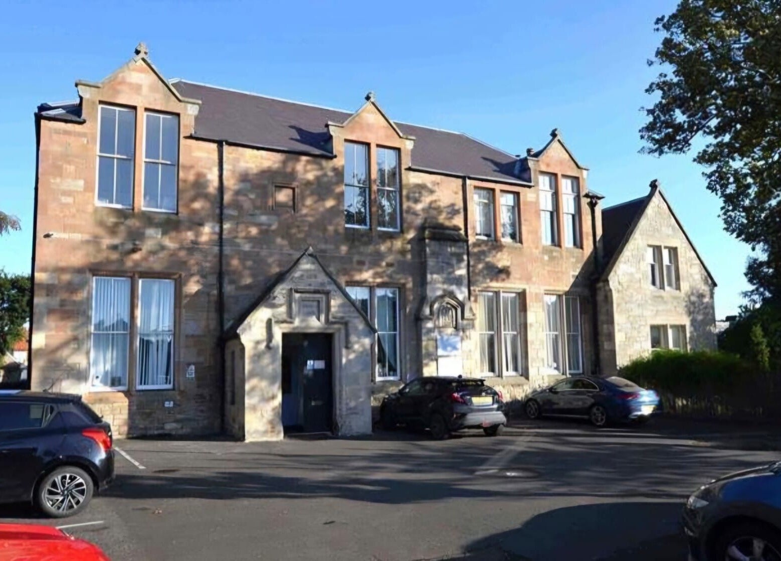 Charming KD Beauty venue in Cockenzie, Scotland, GB, showcasing rustic stone architecture under clear blue sky.
