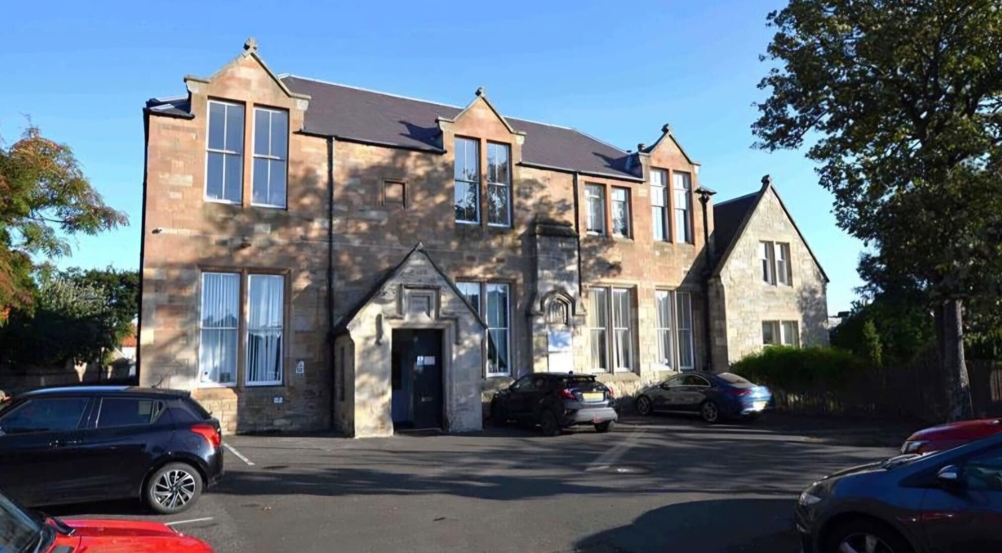 Charming KD Beauty venue in Cockenzie, Scotland, GB, showcasing rustic stone architecture under clear blue sky.