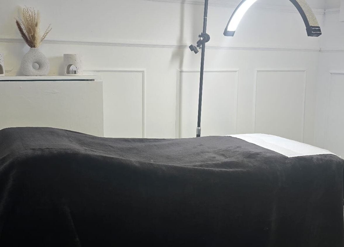 Cozy treatment room at KD Beauty, Cockenzie, Scotland, GB with a massage table and soft lighting.