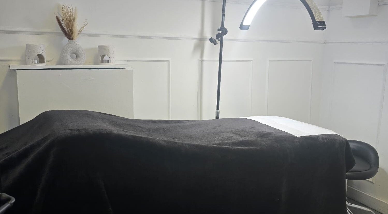 Cozy treatment room at KD Beauty, Cockenzie, Scotland, GB with a massage table and soft lighting.