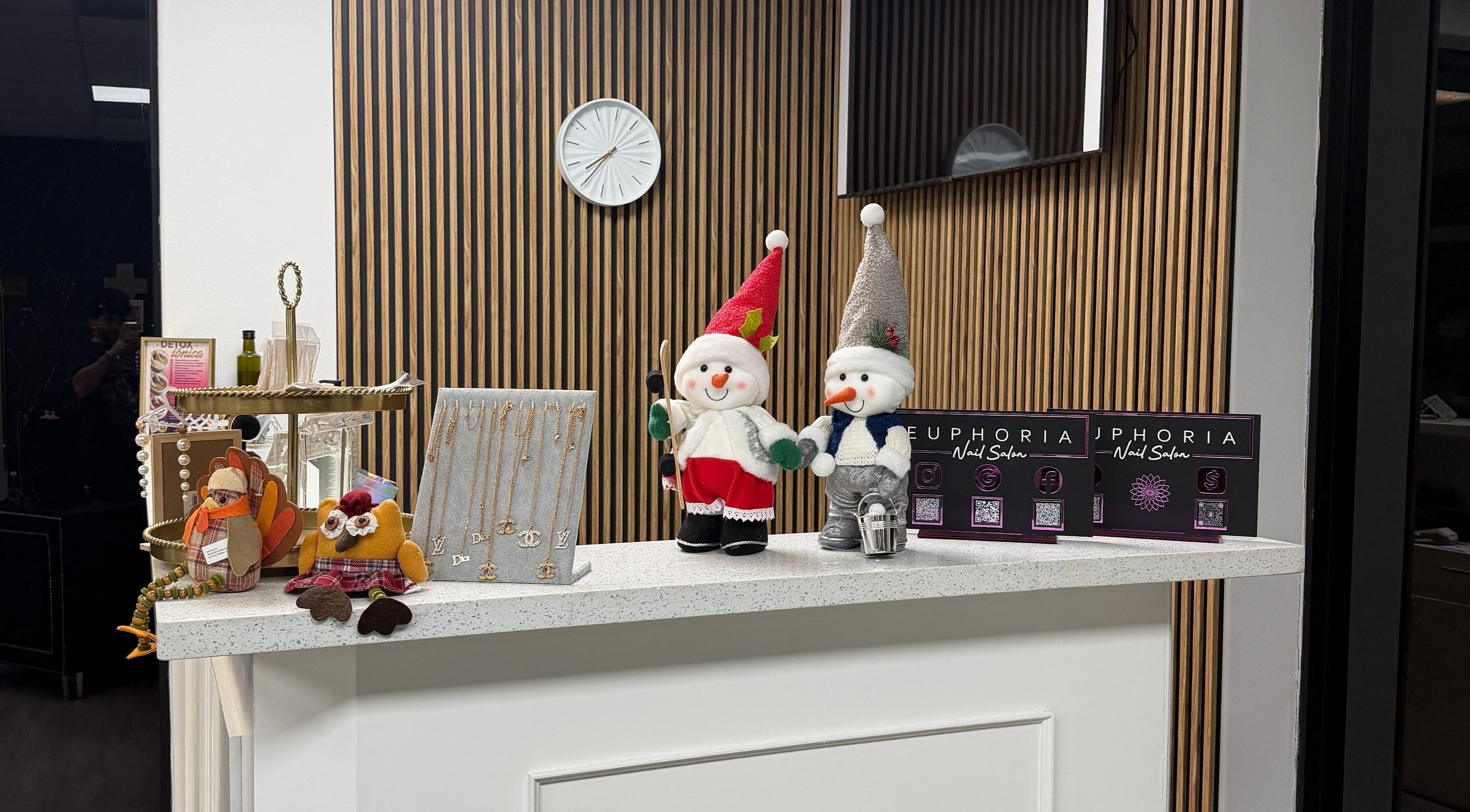 Euphoria Salon in Mcallen, Texas beautifully decorated with festive snowmen and elegant jewelry display.