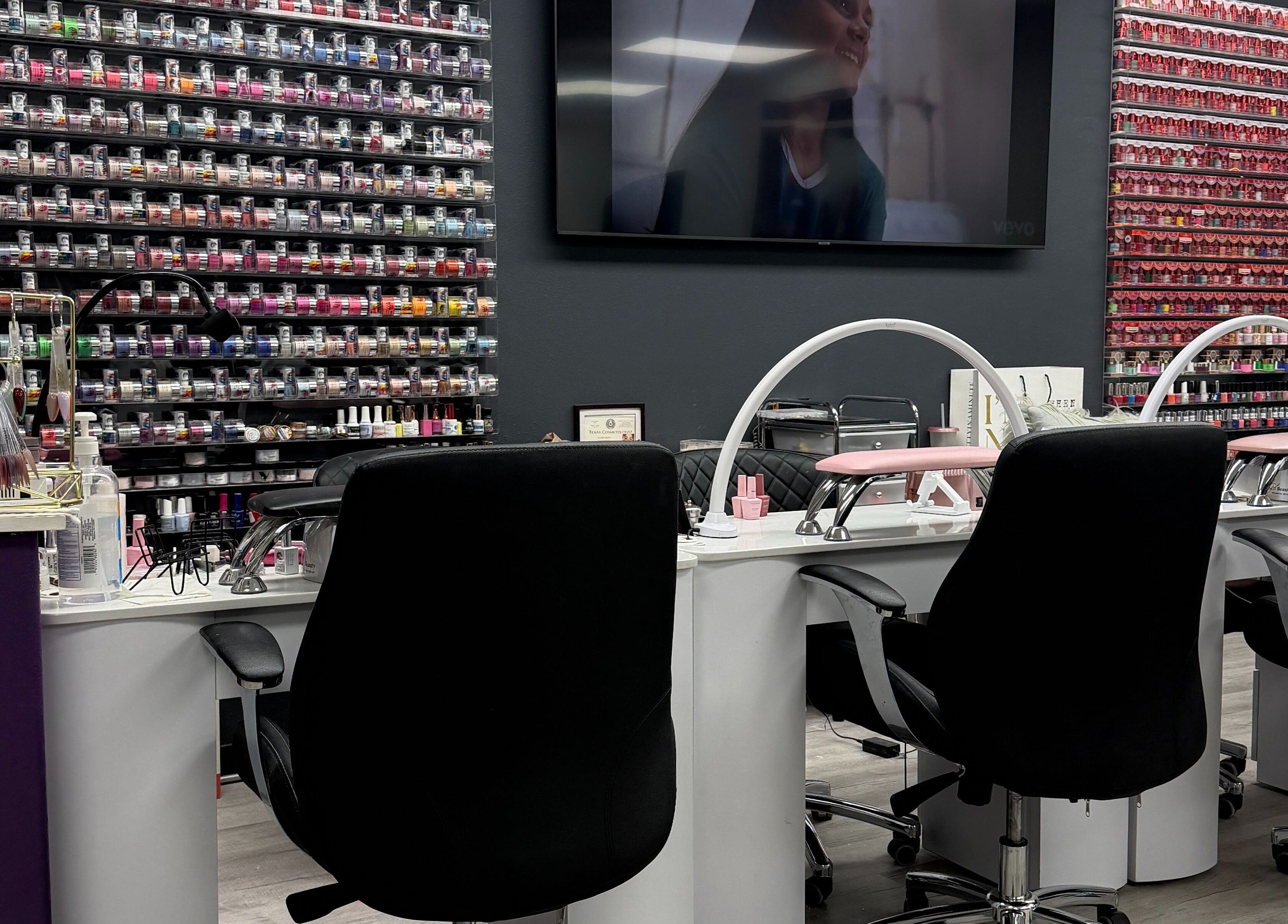 Euphoria Salon nail station in Mcallen, Texas with vibrant polish wall display.