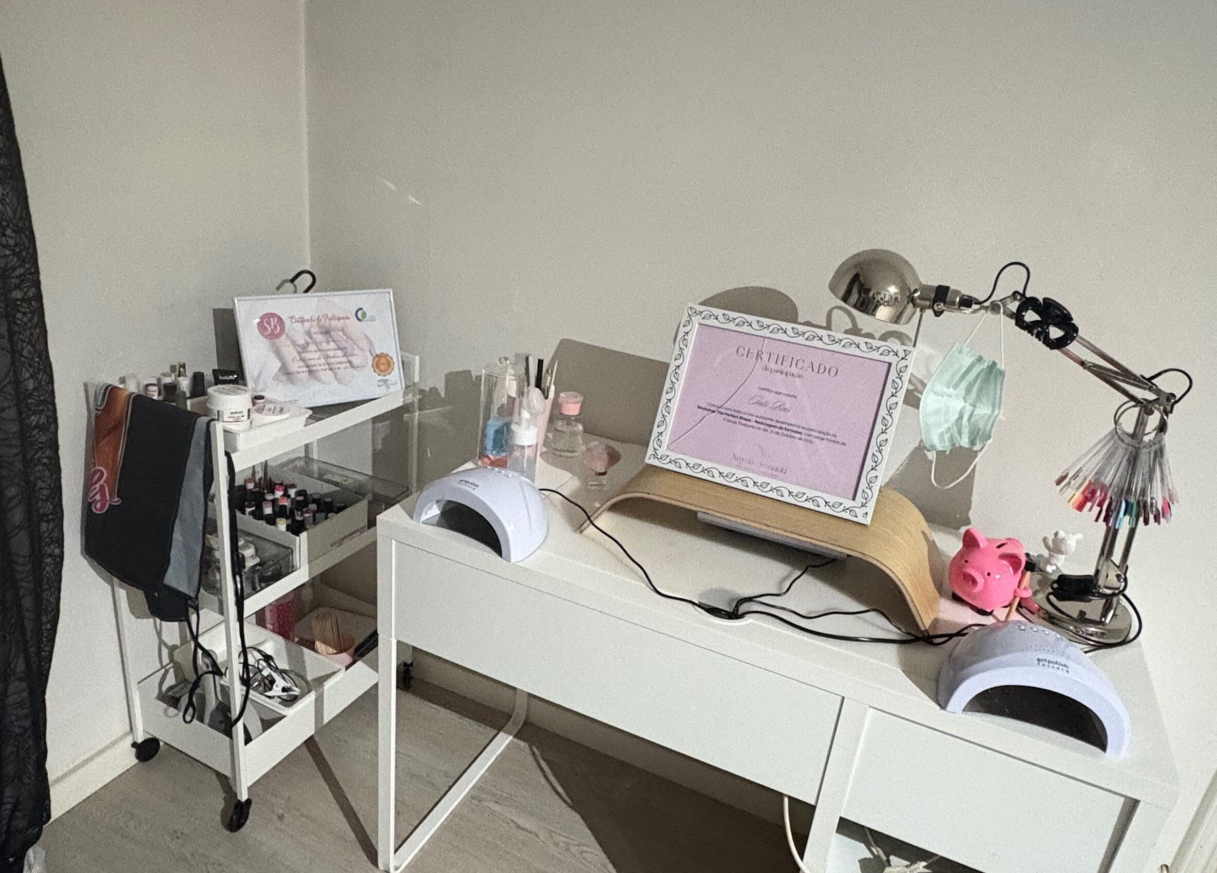 Modern nail studio desk at Thenailsfirst, Queluz, Lisboa, PT, complete with manicure tools and decor.