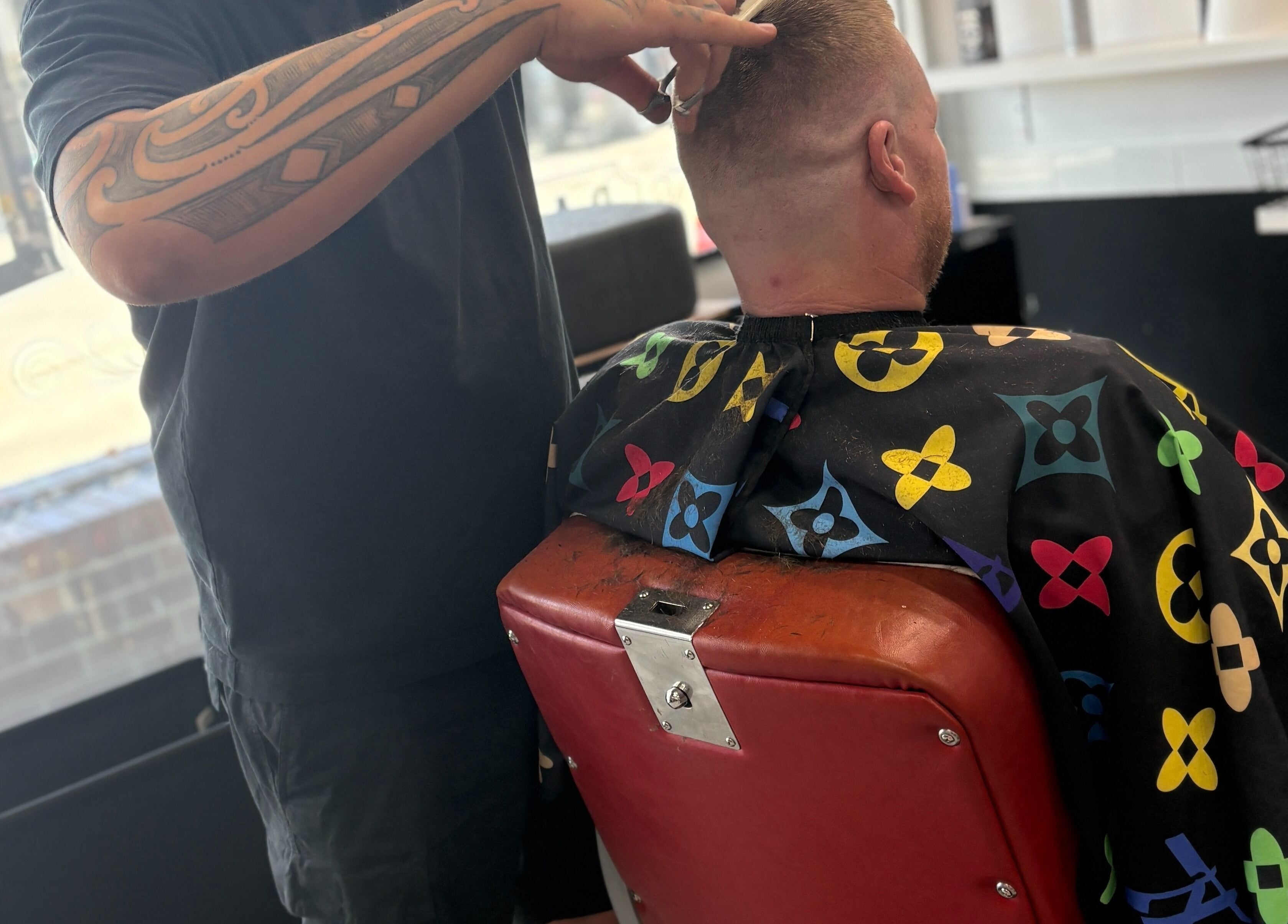 Barber cuts hair at The Elite Barbershop, Fyshwick, ACT, AU, showcasing expert styling skills.