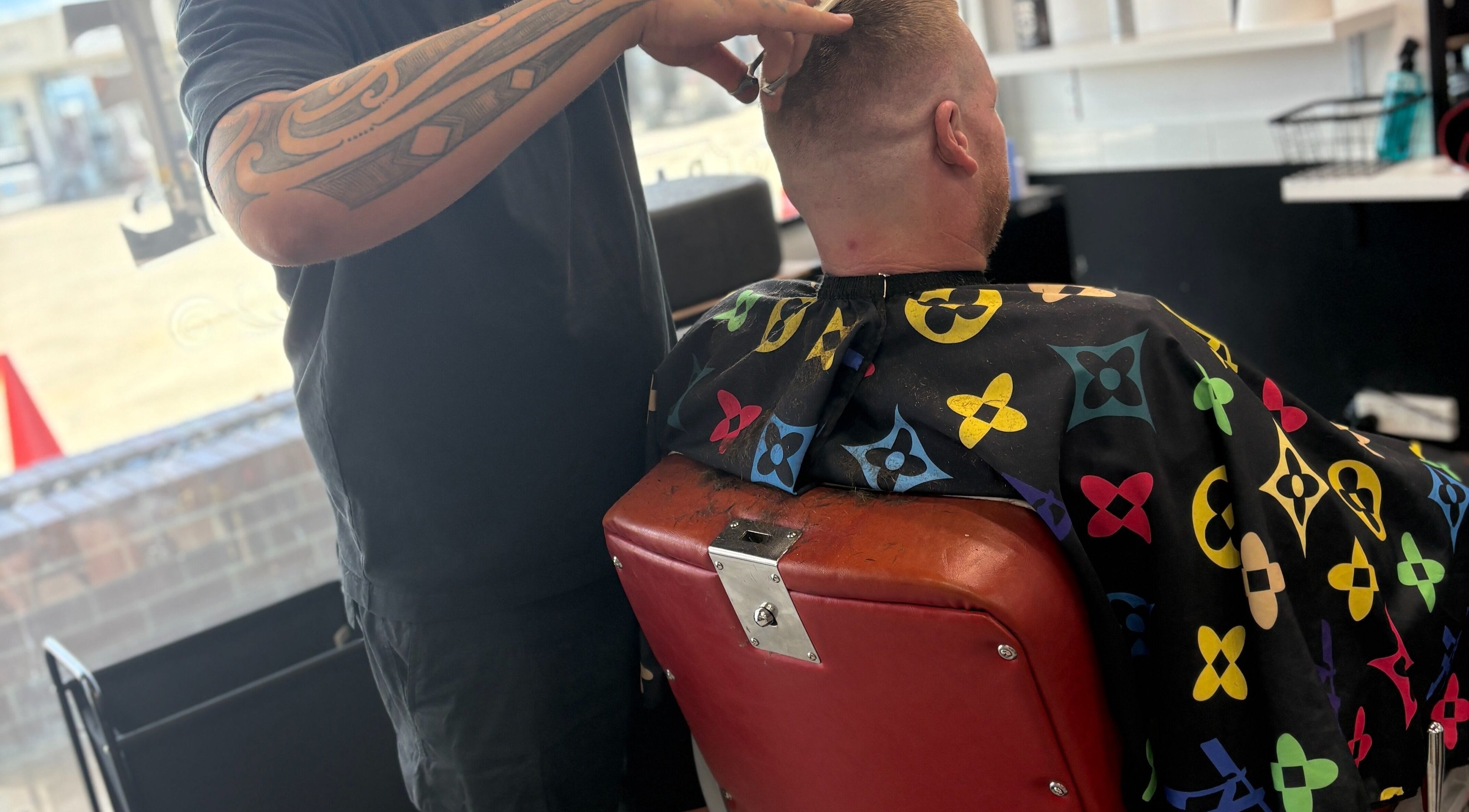 Barber cuts hair at The Elite Barbershop, Fyshwick, ACT, AU, showcasing expert styling skills.