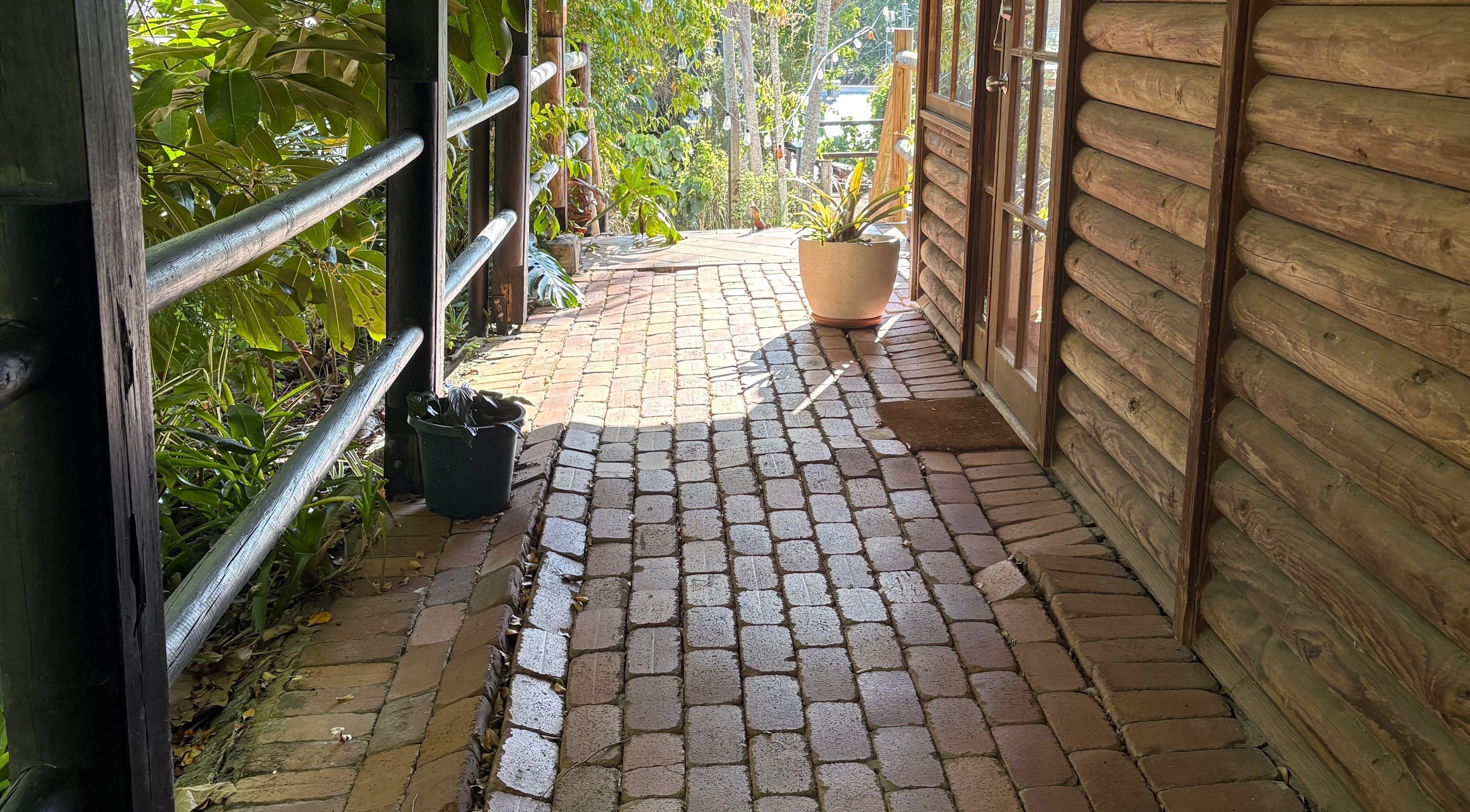 Inviting brick pathway at Melba Stewart Brows & Body, Eumundi, Queensland, AU, offering a serene entryway.
