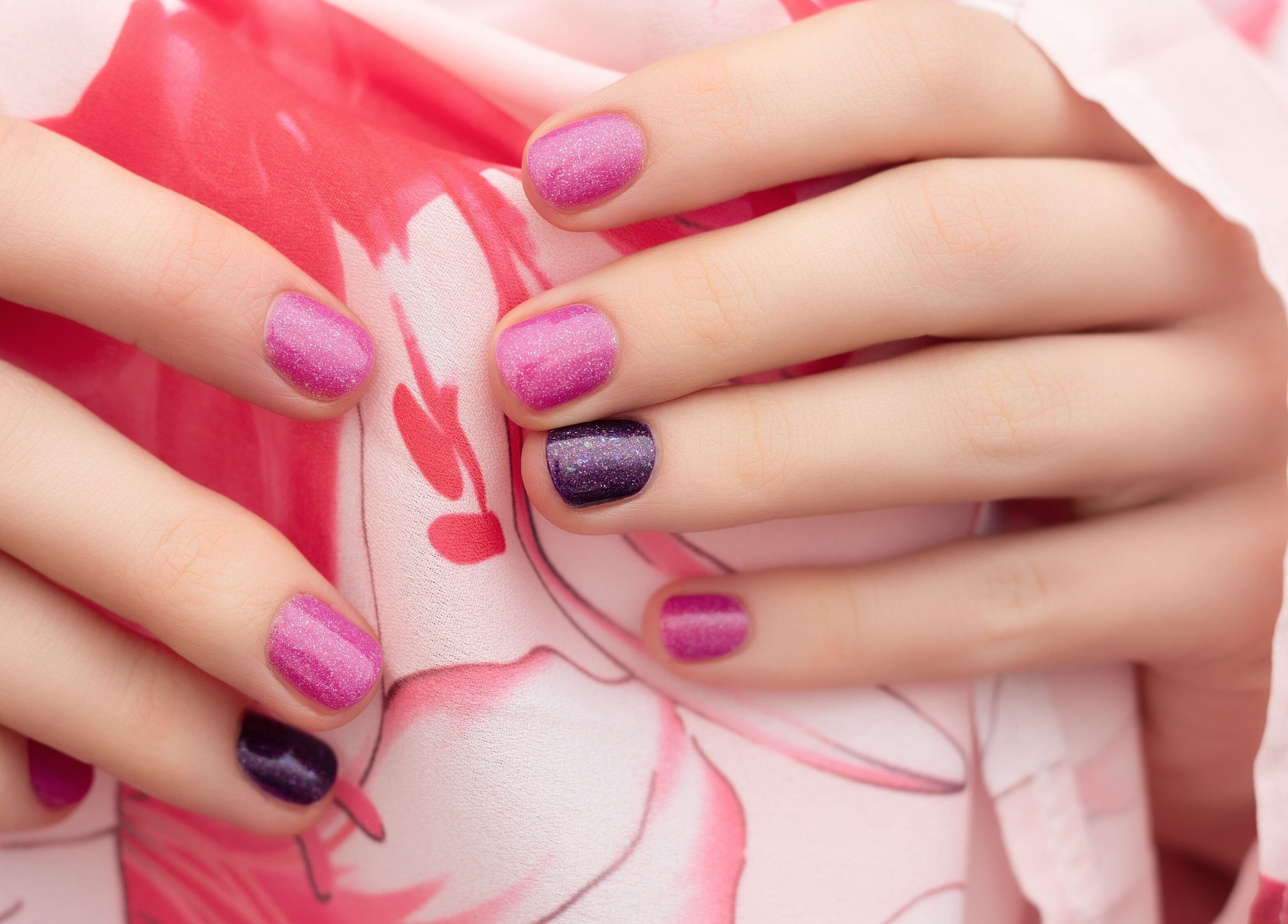 Vibrant pink and purple nails at Edric Spa, Hà Nội, VN. Perfect manicure with floral background.