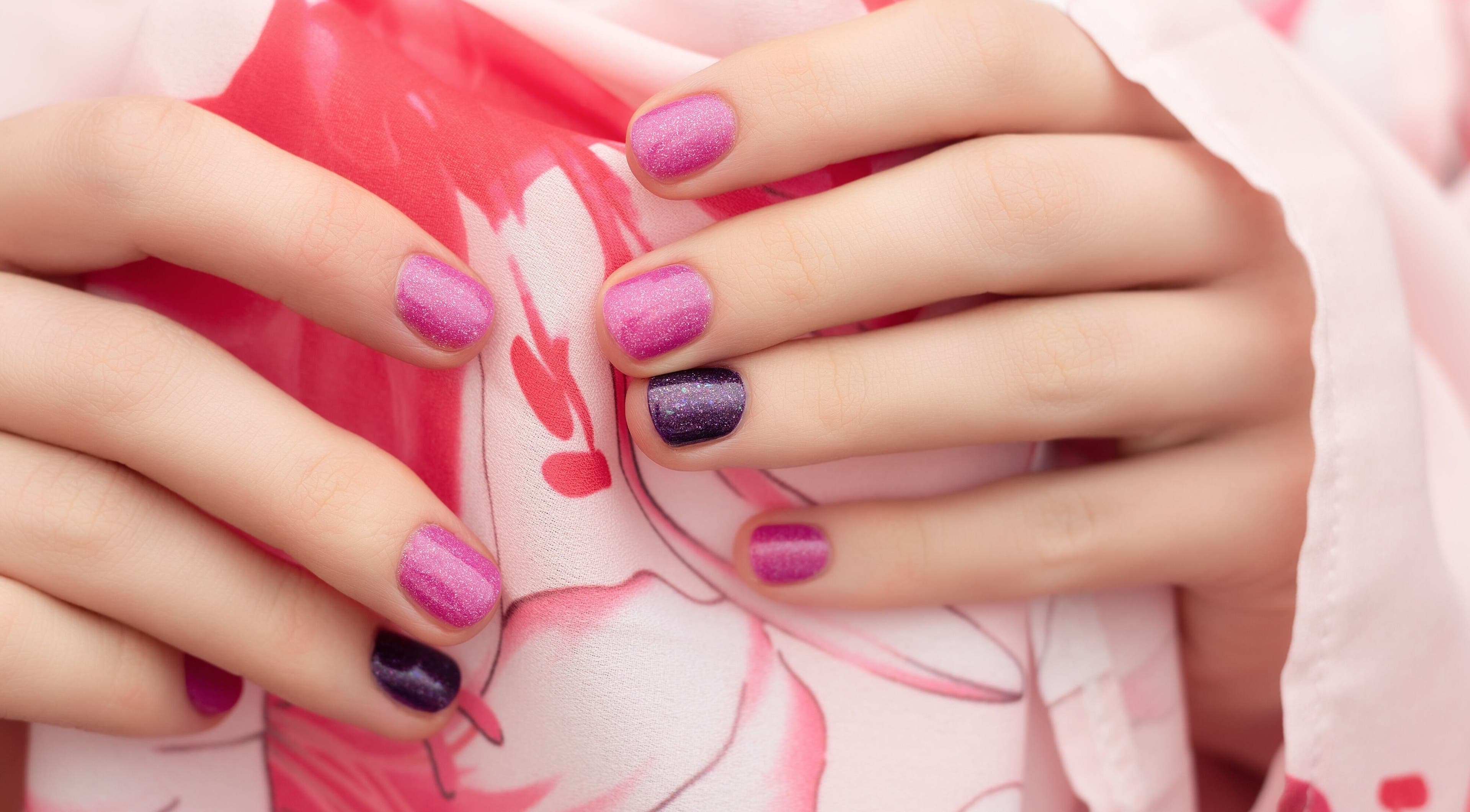 Vibrant pink and purple nails at Edric Spa, Hà Nội, VN. Perfect manicure with floral background.