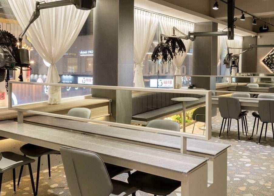Sophisticated interior of Hair The Beau Nowon, 서울특별시, KR, showcasing modern décor and styling stations.