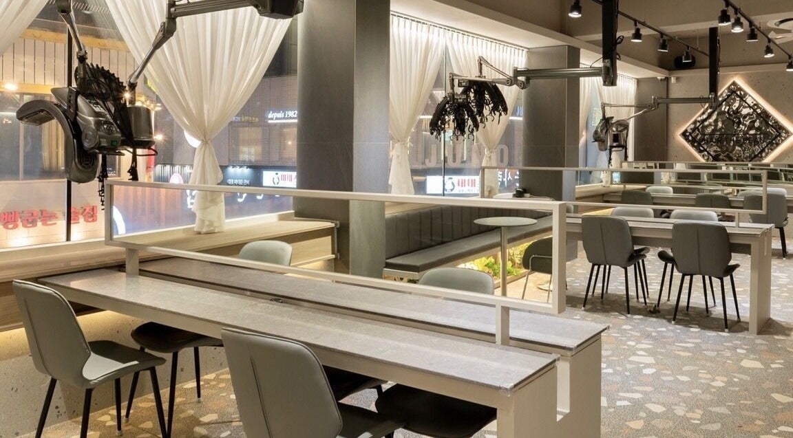 Sophisticated interior of Hair The Beau Nowon, 서울특별시, KR, showcasing modern décor and styling stations.