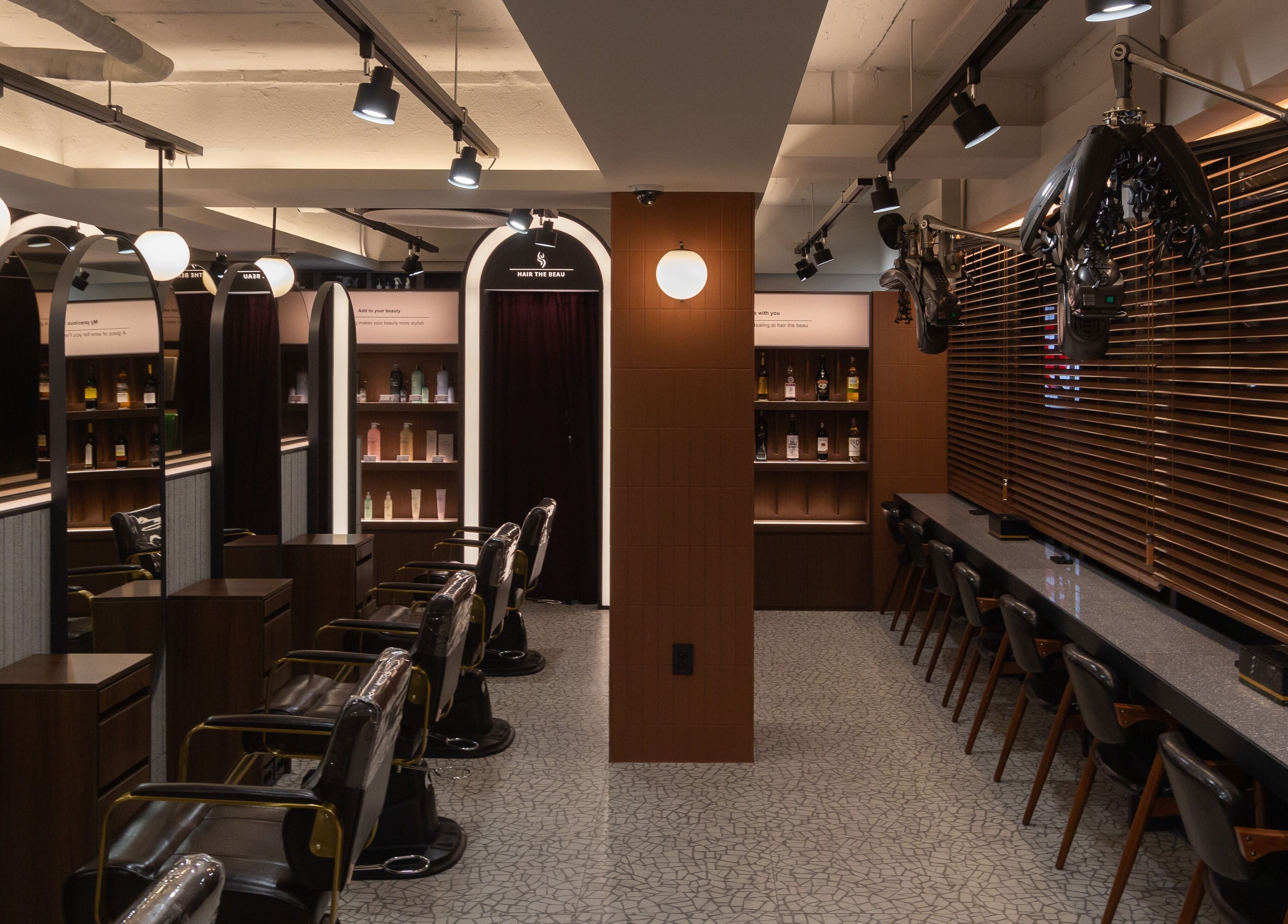 Modern salon interior at HAIR THE BEAU GANGNAM, 서울특별시, 서울특별시, KR, showcasing stylish chairs and decor.