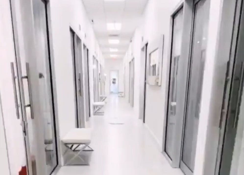 Bright hallway at LuxehairbyJo, Wellington, Florida, US, featuring sleek salon suite doors.
