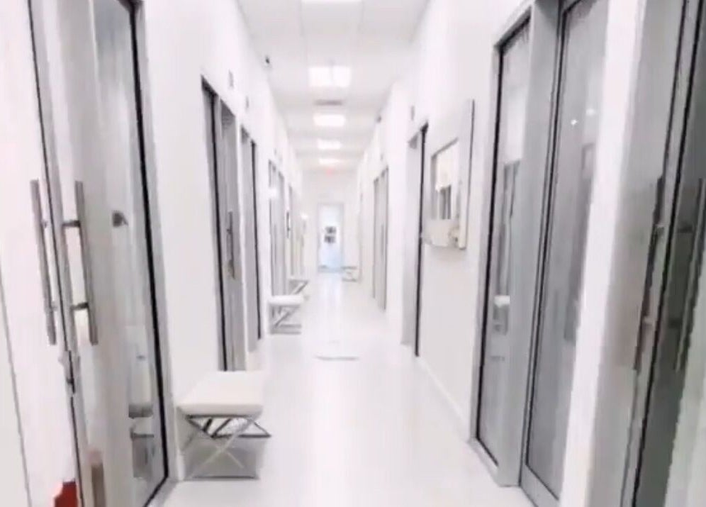 Modern corridor at LuxehairbyJo, Wellington, Florida, US, featuring elegant glass doors.