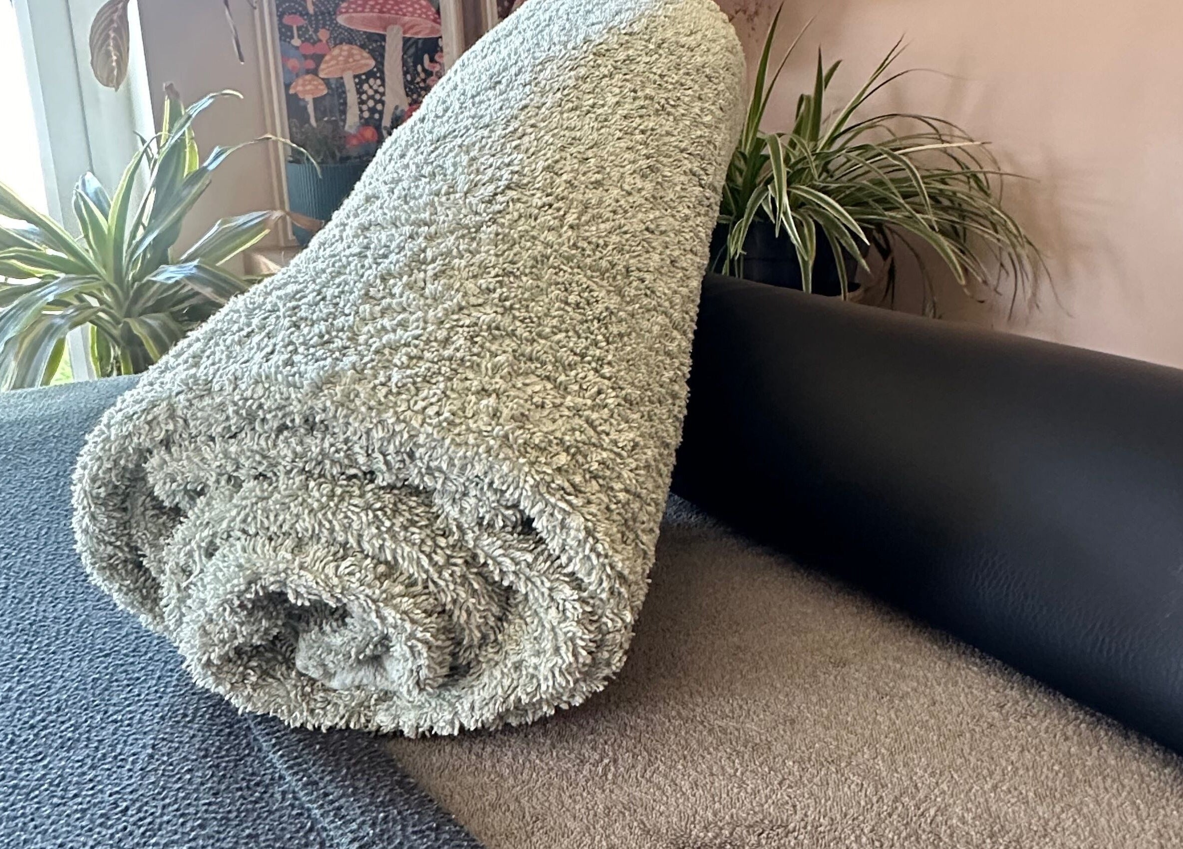Cozy spa setup at Mariners Point, Shoreham-by-Sea, BN43 6DG, featuring a rolled towel and plants.