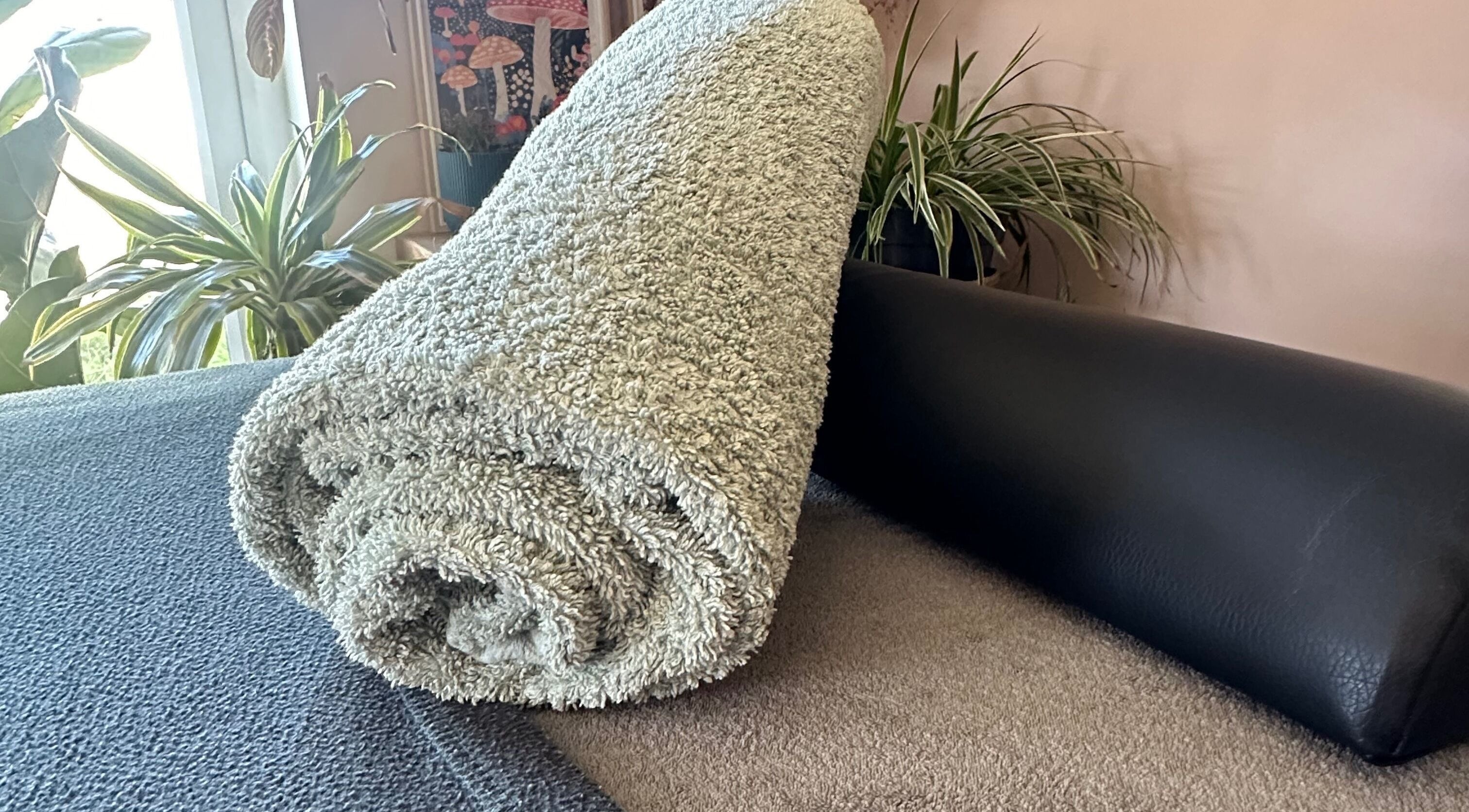 Cozy spa setup at Mariners Point, Shoreham-by-Sea, BN43 6DG, featuring a rolled towel and plants.