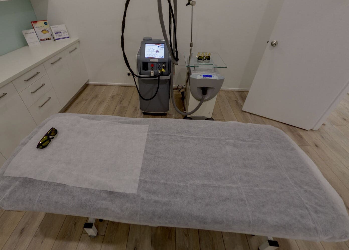 Treatment room at Skin and Laser Studio, St Leonards, New South Wales, AU, featuring a laser machine and bed.