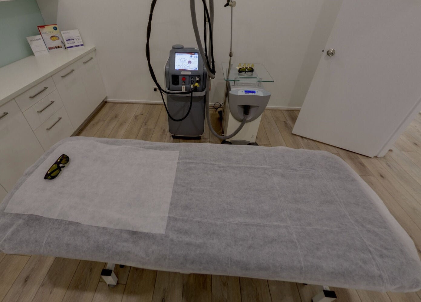 Treatment room at Skin and Laser Studio, St Leonards, New South Wales, AU, featuring a laser machine and bed.