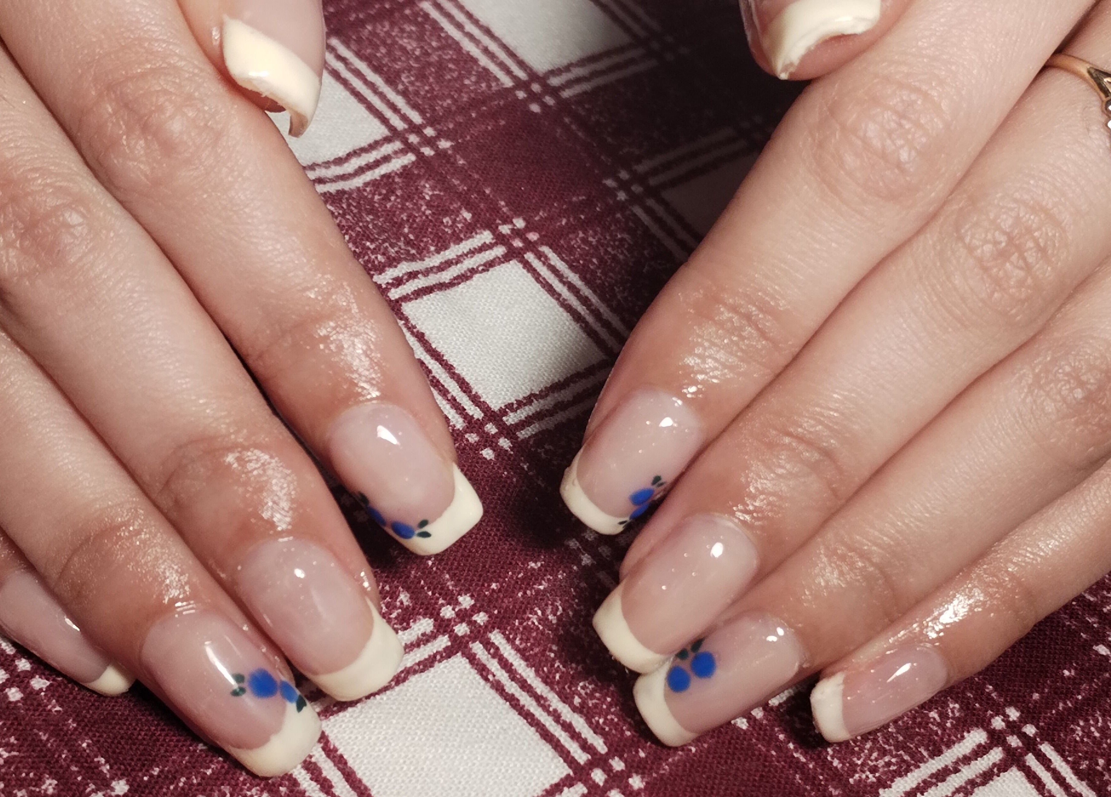 Elegant French manicure with floral designs at Nails By Courtney in Cape Town, Western Cape, ZA.