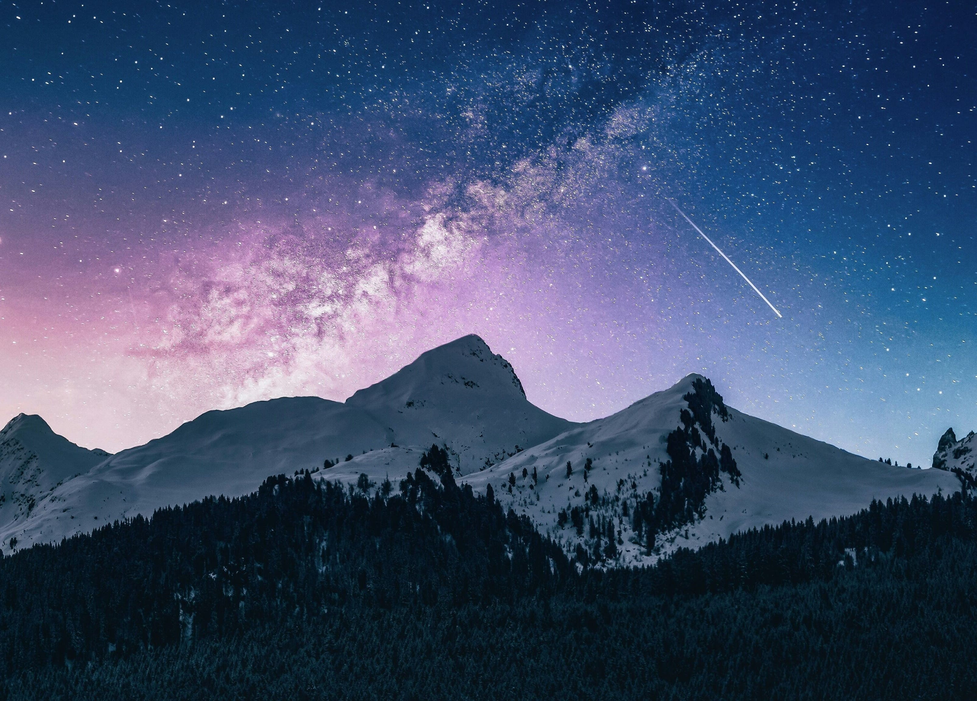 Starry night sky over snowy peaks near Le Forbici di Fede, Castello Di Cisterna, Campania, IT.