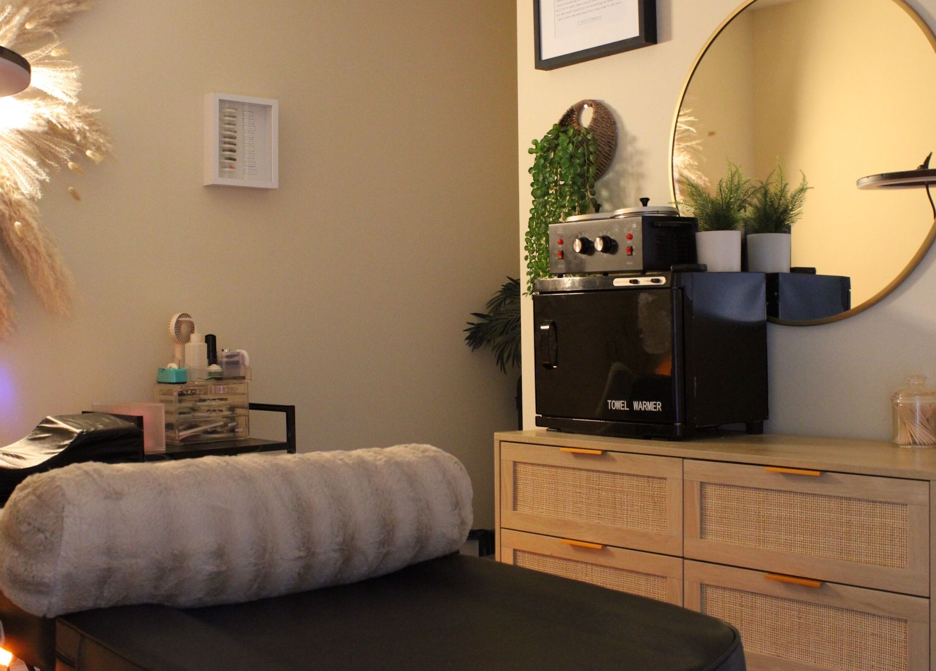 Cozy treatment room at Orbit Esthetics, Covington, Kentucky, US with spa amenities and calming decor.