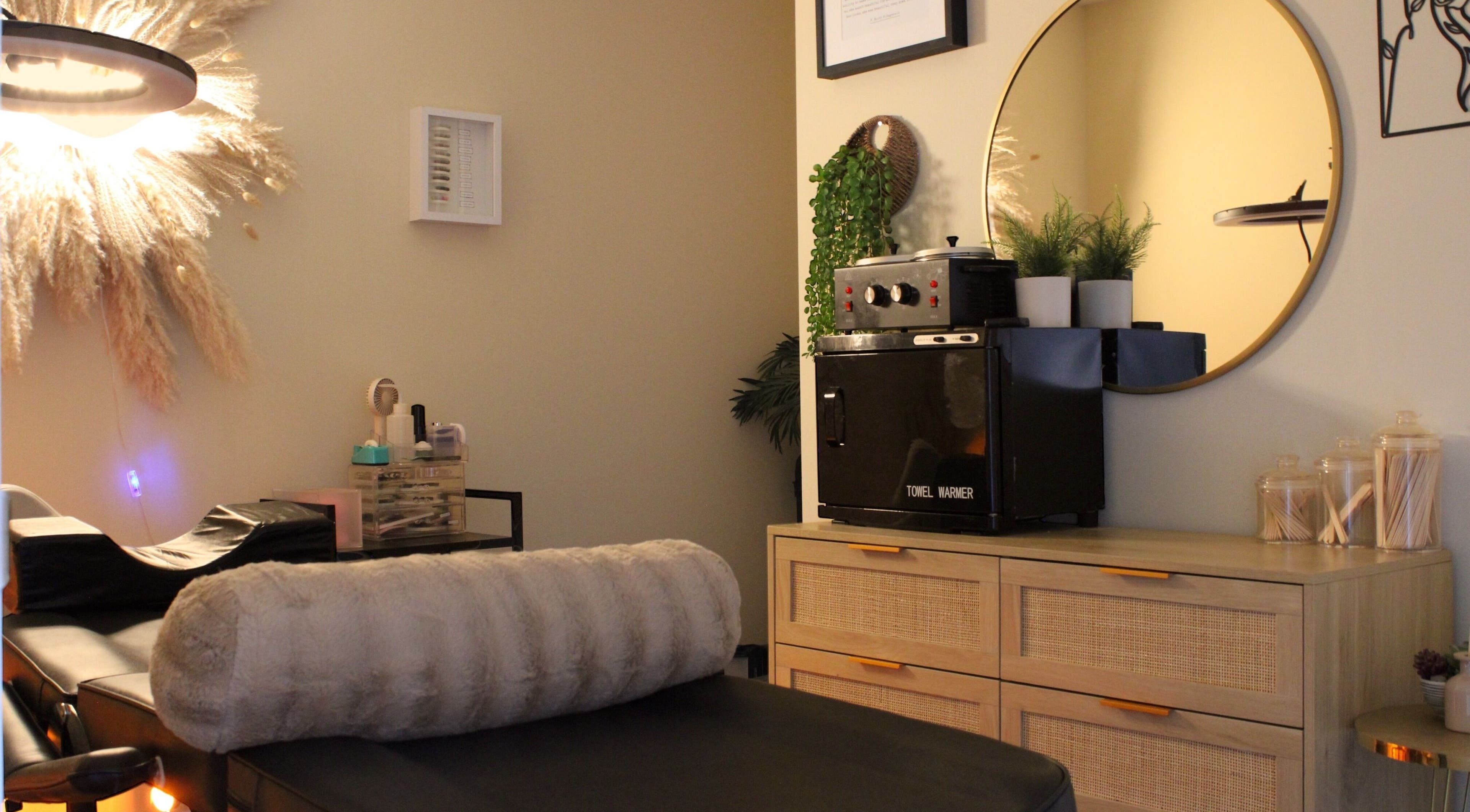 Cozy treatment room at Orbit Esthetics, Covington, Kentucky, US with spa amenities and calming decor.