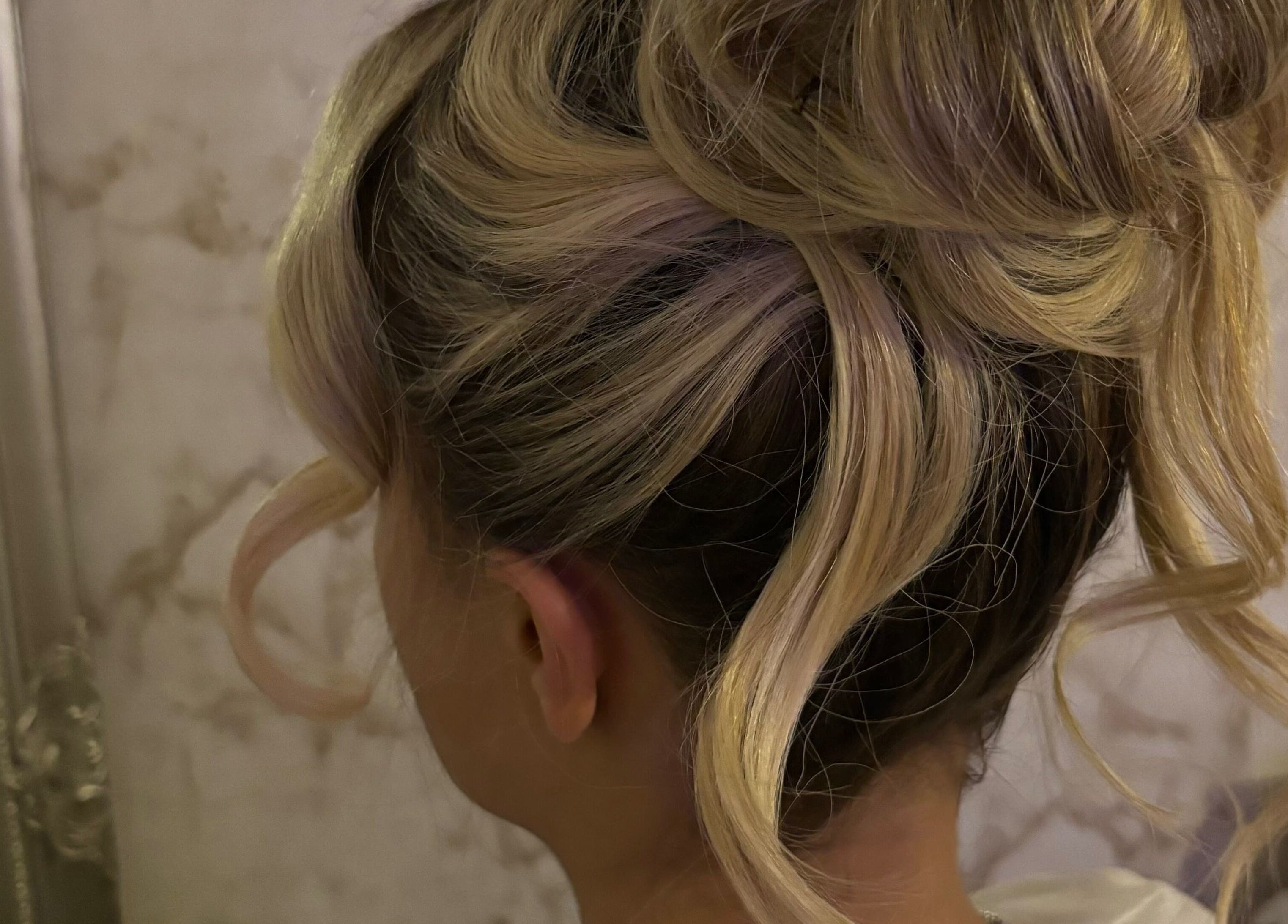 Elegant updo hairstyle at LM Blowdries, Bettws, Wales, GB showcasing blonde curls and style.